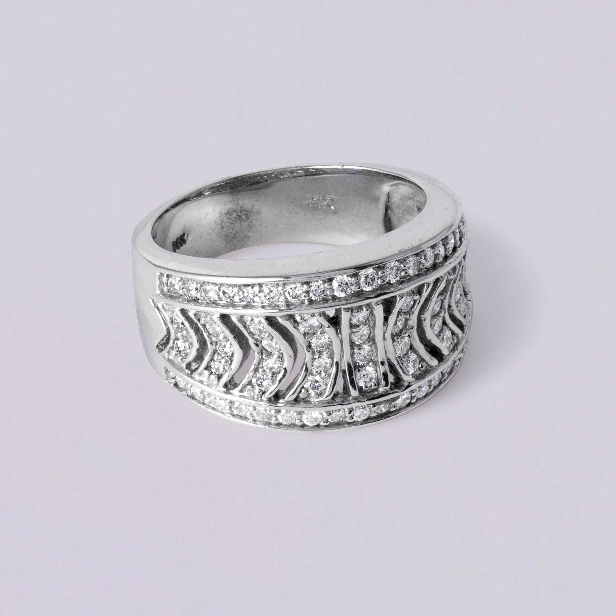 Bold and chic wide gold band, featuring 66 round brilliant diamonds pavé set in an eye-catching, modern pattern. The diamonds, totaling 0.63 carats, are high-quality G/H color and VS clarity, offering bright, clean sparkle throughout. Crafted in