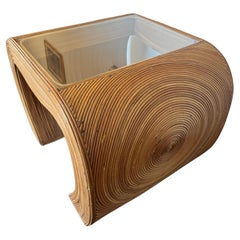 Gorgeous pencil reed end table with a glass top in the style of Gabriella CrespI