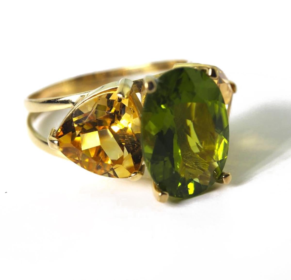 Clear beautiful bright green 6 carat oval Peridot enhanced with 5 carats of brilliant yellow Citrine trillions set in a handmade unique 18 Karat yellow gold ring size 7.  (sizable)  If you wish faster delivery on your purchase choose UPS to ship for