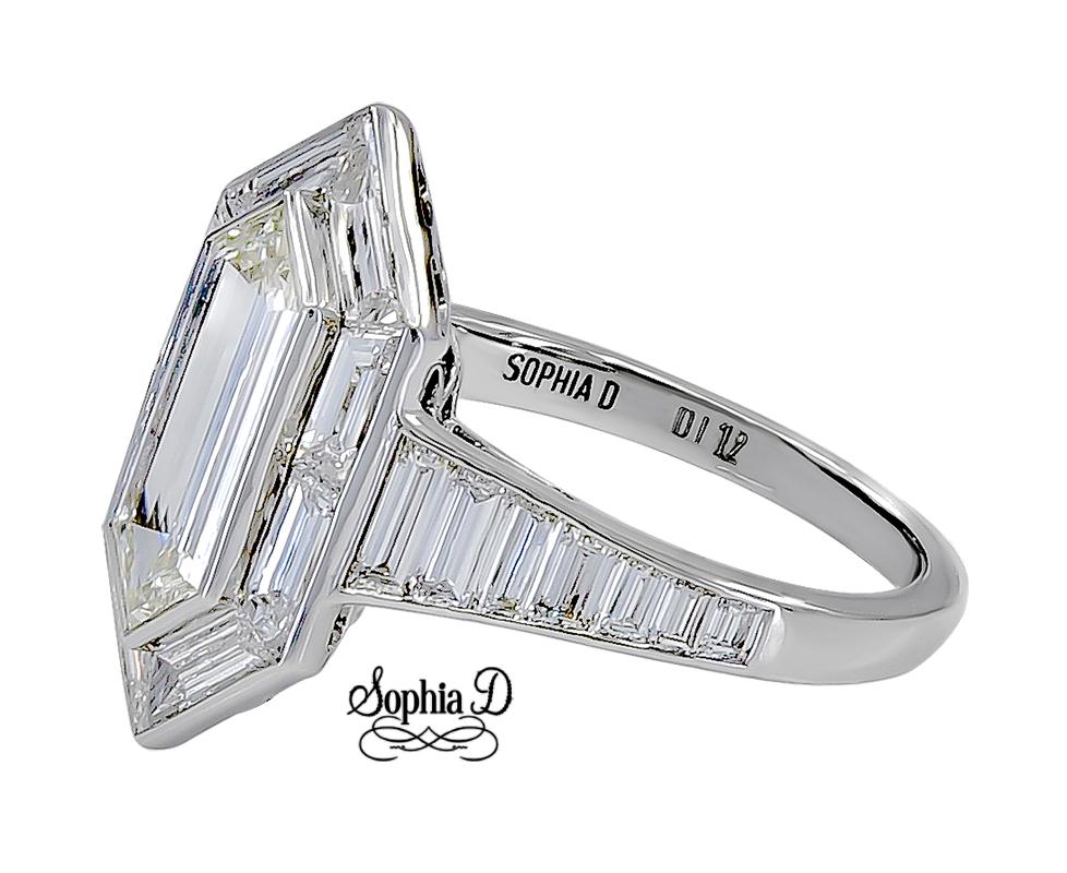 Platinum diamond ring with center weighing 1.12 carats, 2 side baguette diamonds with a total weight of 1.08 carat and 0.68 carat diamonds on the shank of the ring.
