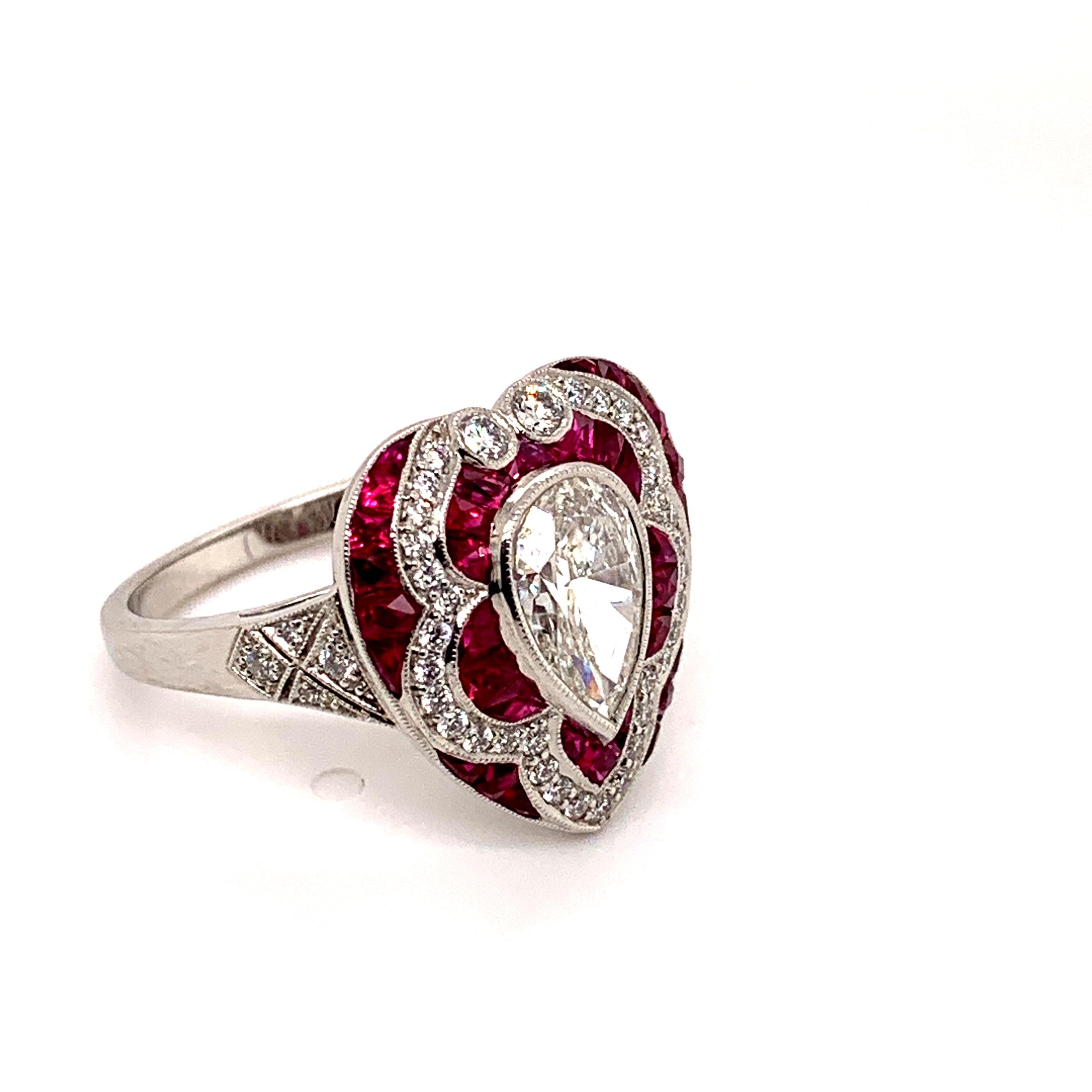 1.30 carat pear shaped diamond ring with 1.20 carat rubies. Round diamond total weight 0.33. Set in Platinum. 

Sophia D by Joseph Dardashti LTD has been known worldwide for 35 years and are inspired by classic Art Deco design that merges with