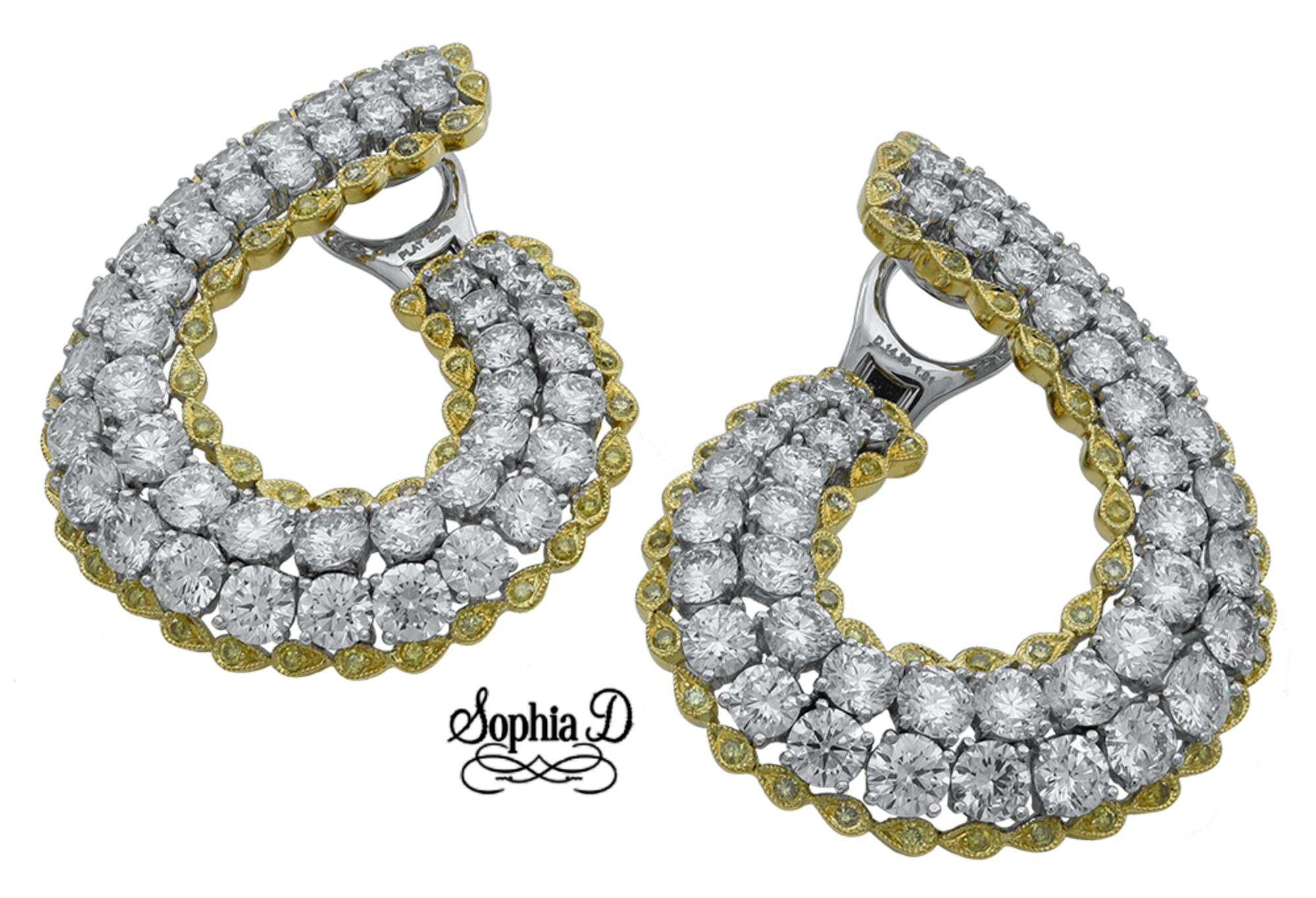 Gorgeously designed by Sophia D, this diamond and yellow sapphire earrings set in platinum is with round cut diamonds weighing 14.39 carats and yellow sapphires weighing 1.01 carats.

Sophia D by Joseph Dardashti LTD has been known worldwide for 35
