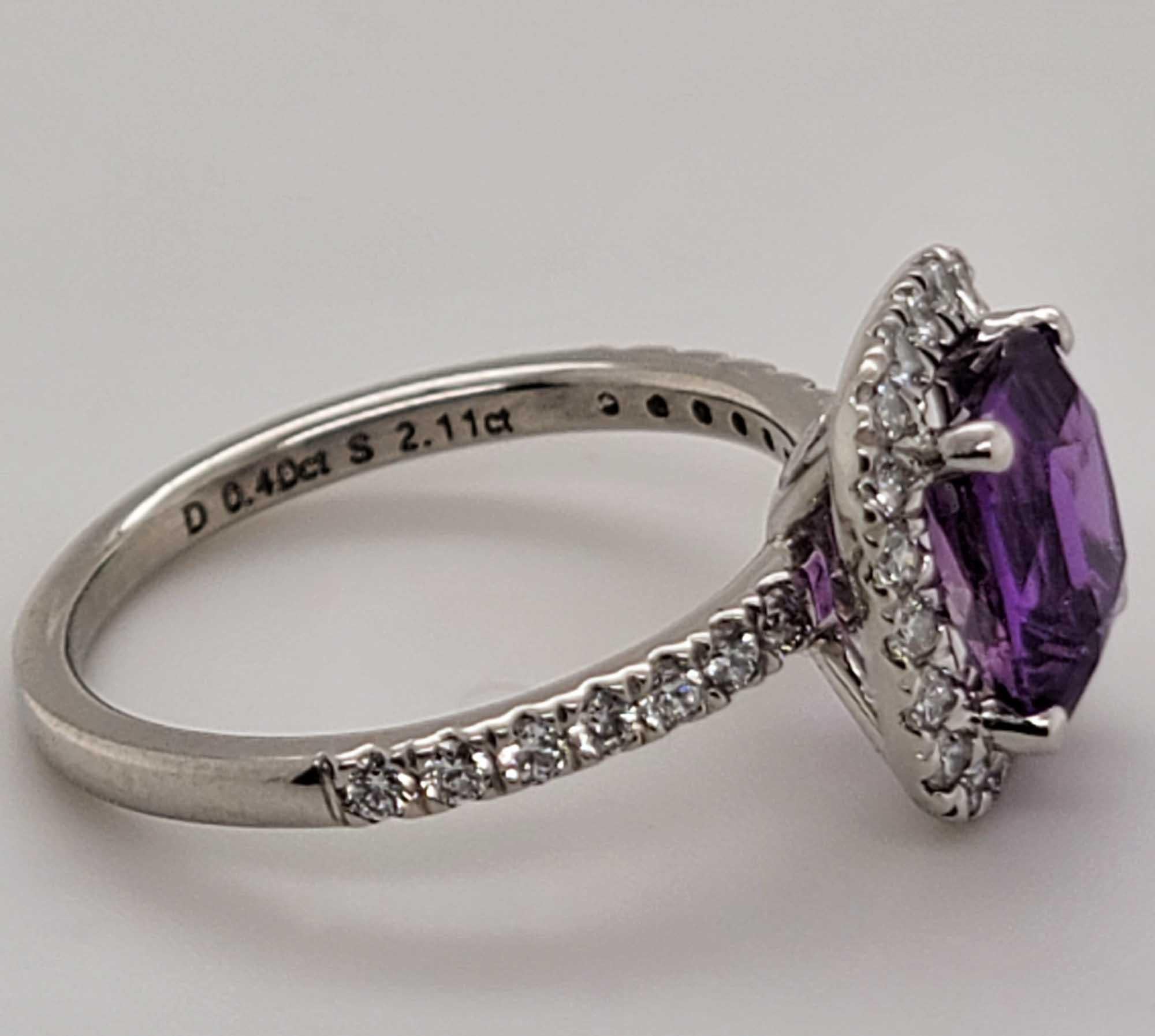 This undeniably elegant styled ring composed of pink sapphire 2.11 cts, surrounded by round diamonds weighing 0.40 cts. 