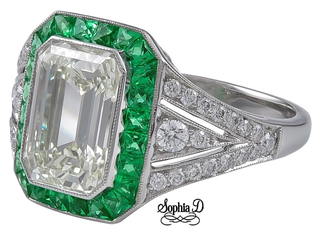 Sophia D Art Deco platinum ring that features a 2.75 carat emerald cut center diamond surrounded with .41 carats of diamonds and .50 carats of emeralds. Ring size is a 6 and available for resizing. 

Sophia D by Joseph Dardashti LTD has been known