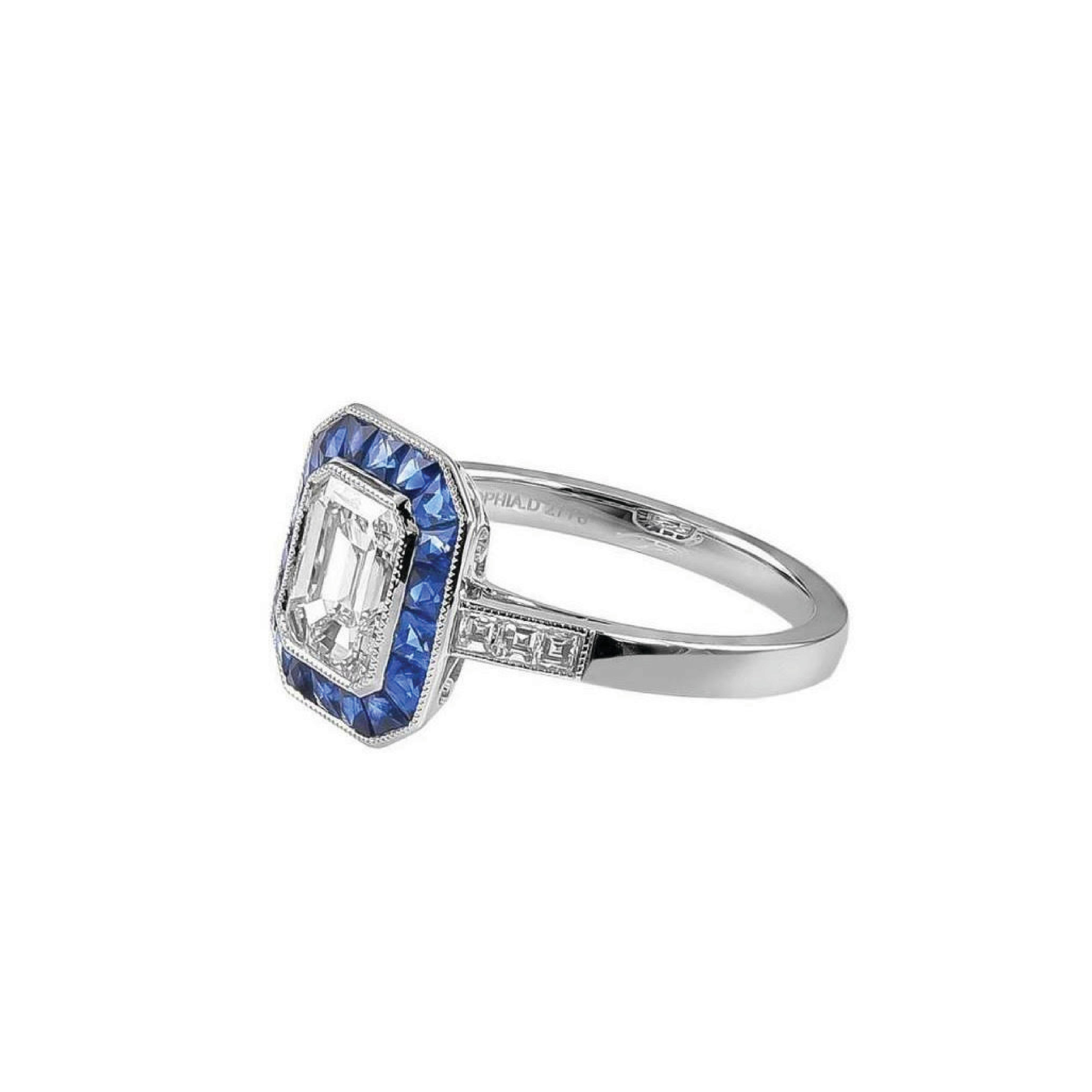 This undeniably elegant styled ring composed of GIA certified Emerald Cut Diamonds that weighs 1.03 carats and has a color and clarity of D-VVS2, with French Cut Sapphire 0.70 carats, surrounded by Small Diamonds weighing 0.24 carats.