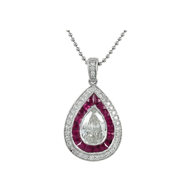 Platinum Set Pendant and Chain with Rubies weighing 0.73 carat and Center Pear Shape Diamond weighing 1.01 carat and smaller Diamonds with a total weight of 0.29 carats.
