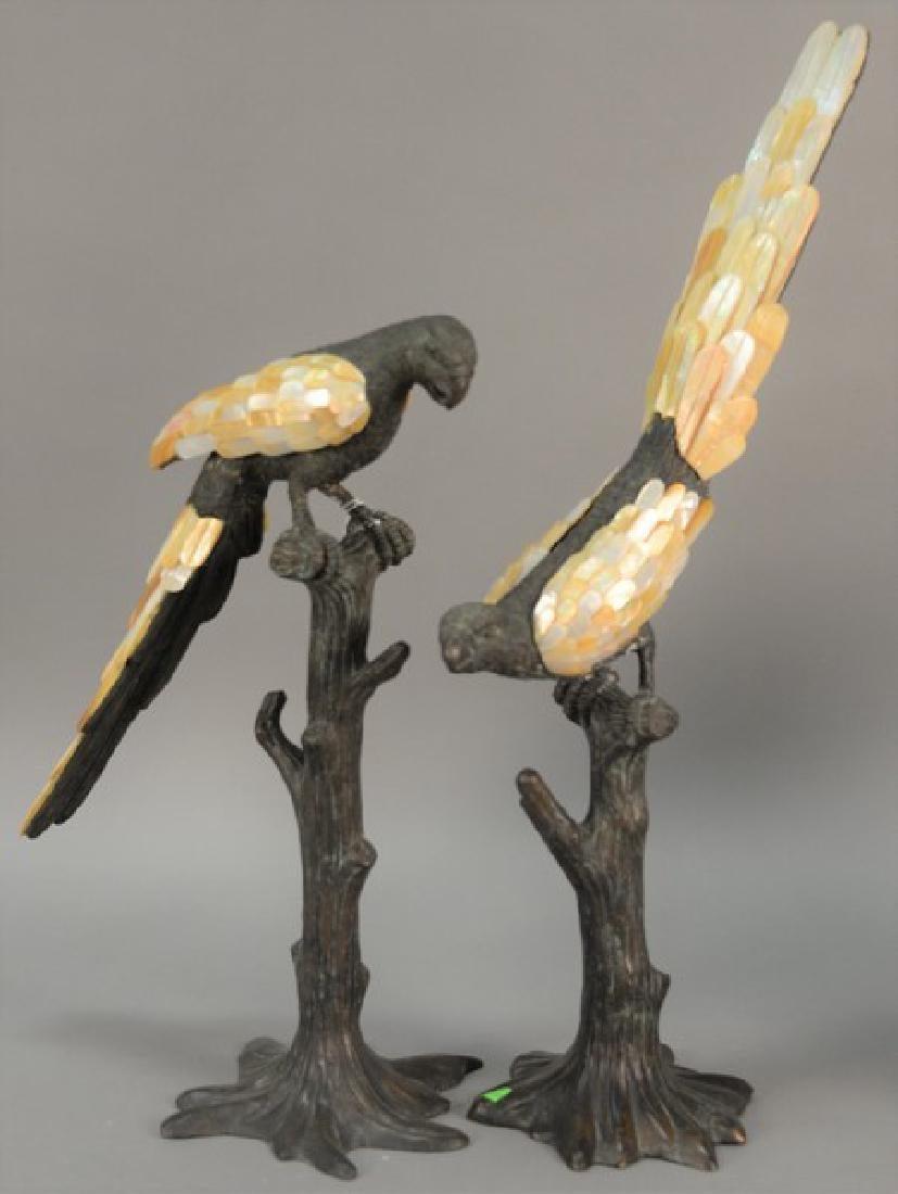 The Following Items we are offering are a Rare Pair of Large Original Maitland Smith Impressive Cast Bronze and Patinated Parrots resting on Tree Stumps, their wing and tail feathers rendered in carved MOP wing and tail feathers rendered in carved