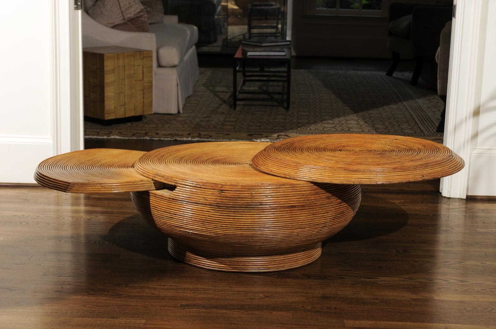 A stunning restored vintage coffee table, circa 1975. Lovely expertly crafted mahogany form painstakingly veneered in thin reed style bamboo. The tabletop and hidden shelf extended to expand the table surface area. A fabulous piece of organic