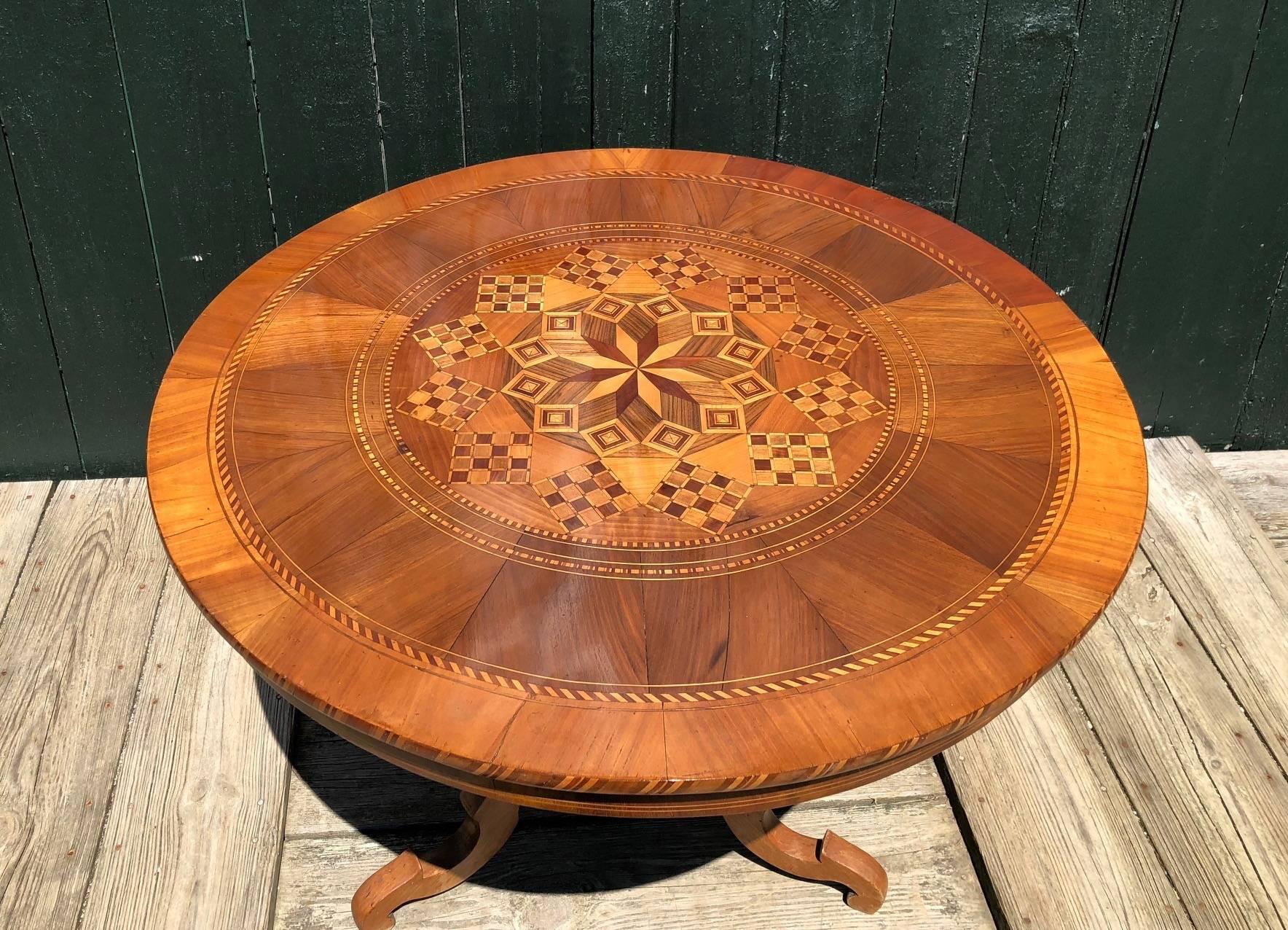 Gorgeous round French walnut marquetry table with magnificent craftsmanship resting on pretty turned tripod pedestal. Perfect in an entry or as an accent table. Just received from Avignon, France.