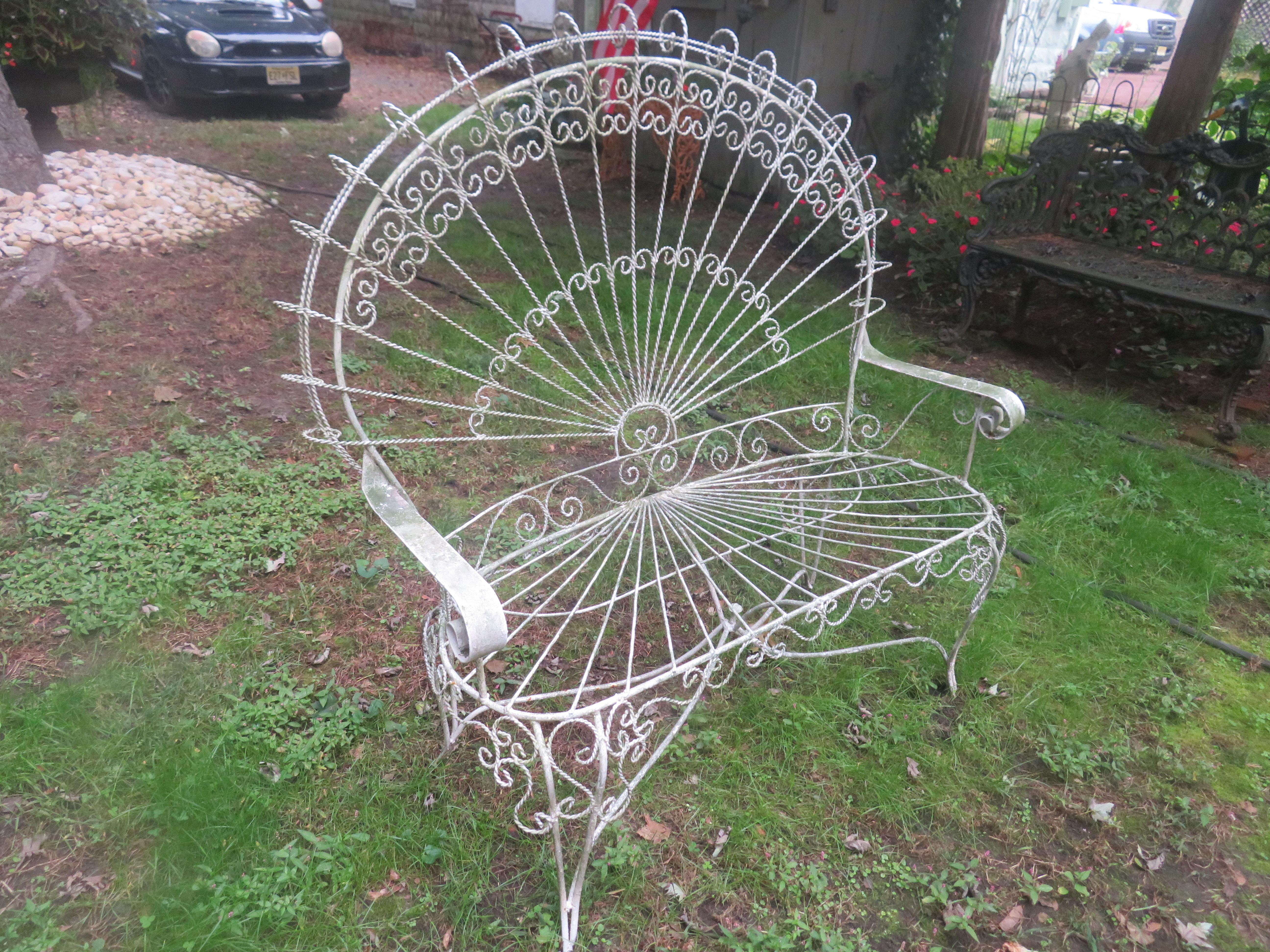 Gorgeous Salterini style ornate wrought iron twisted wire fan back patio bench. This piece is in vintage condition retaining it's original white finish with a lovely green lichen patina. There are no cracks or breaks to the frame-sturdy.