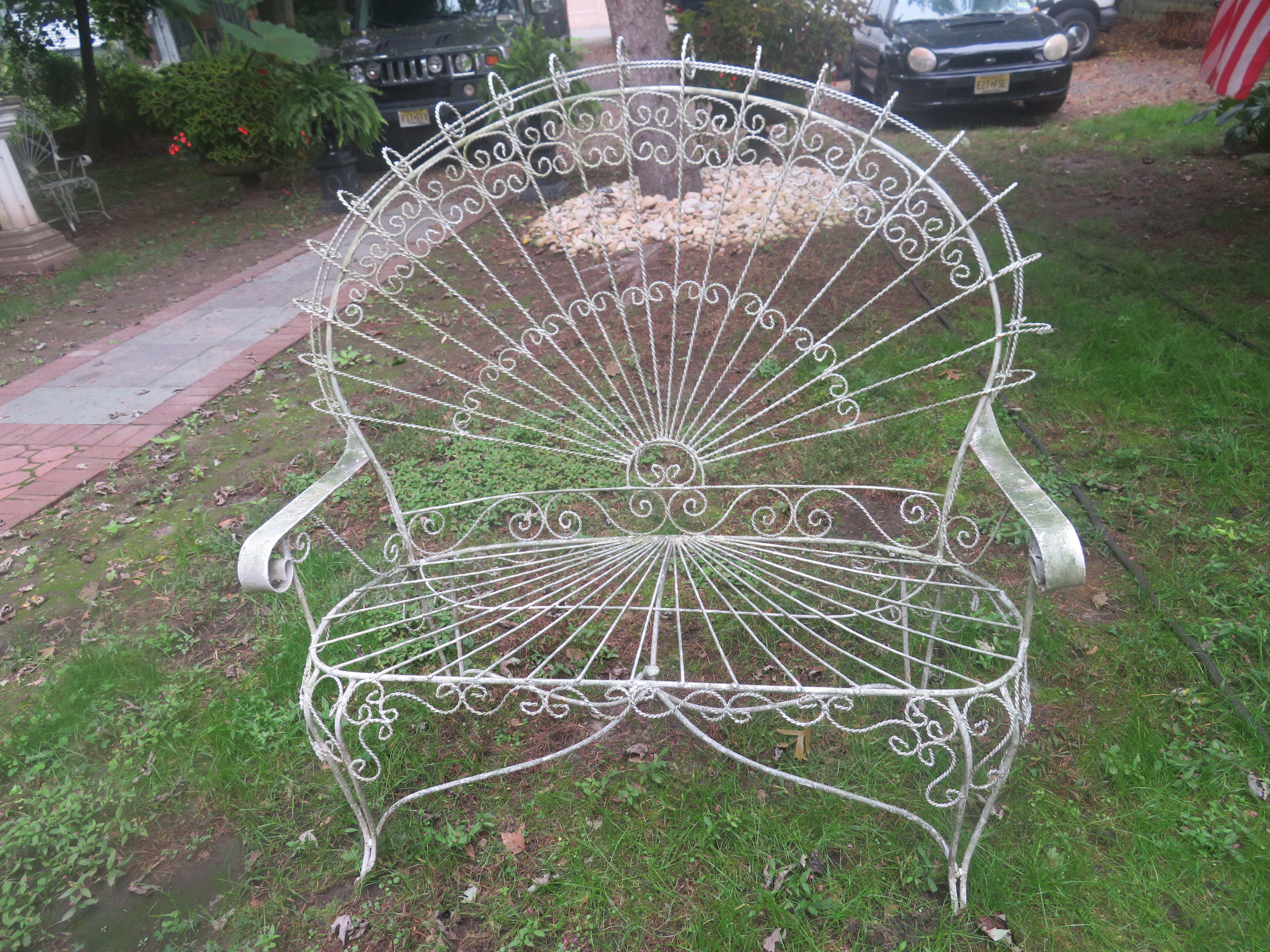 Gorgeous Salterini style ornate wrought iron twisted wire fan back patio bench. This piece is in vintage condition retaining it's original white finish with a lovely green lichen patina. There are no cracks or breaks to the frame-sturdy. Please not