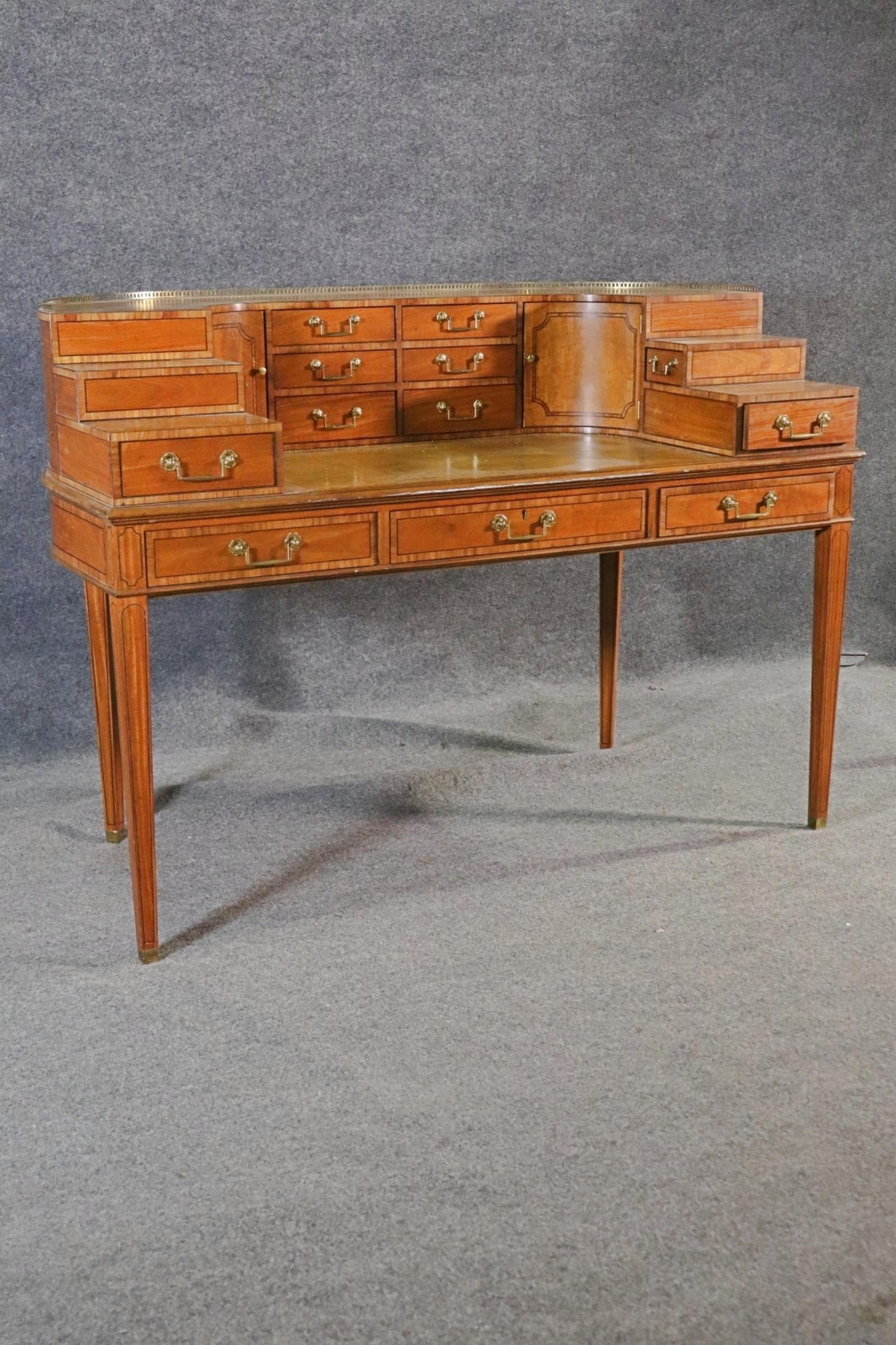 Baker Furniture company, bureau en noyer de style Carlton House. Le dessus est entouré d'une galerie en laiton.  Design/One.  Beau haut en cuir. 


Dimensions : 38 1/2
