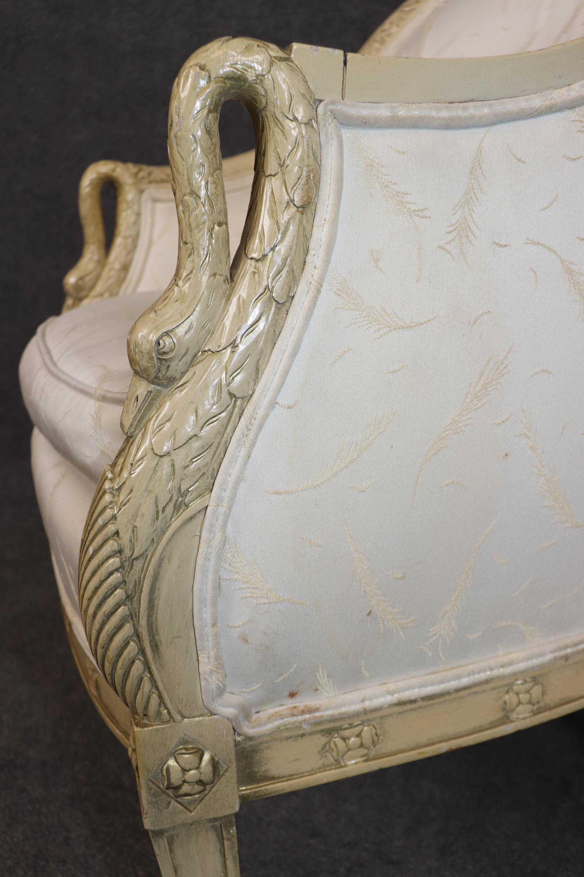 Beautiful single French swan bergere chair. Measures 35.75 tall x 25 wide x 25 deep and seat height 20 inches. French made chairs. Distressed finish in yellowish white. 
