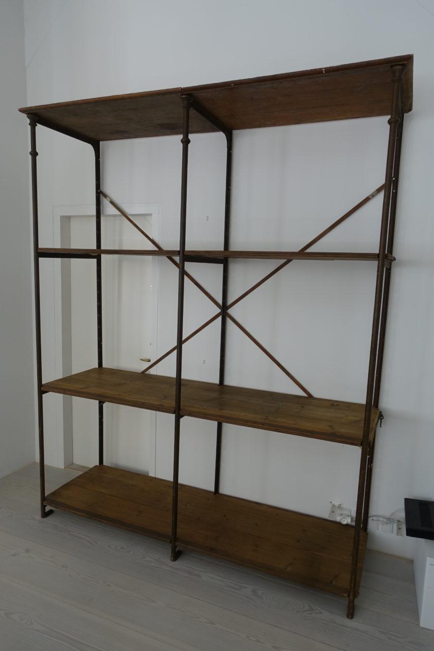 Rustic and large vintage industrial / warehouse shelves from France, super patina on its iron frame and with several long deep wooden shelves. This bookcase dates back to circa 1900, and is elegantly constructed of a slim iron frame with charming