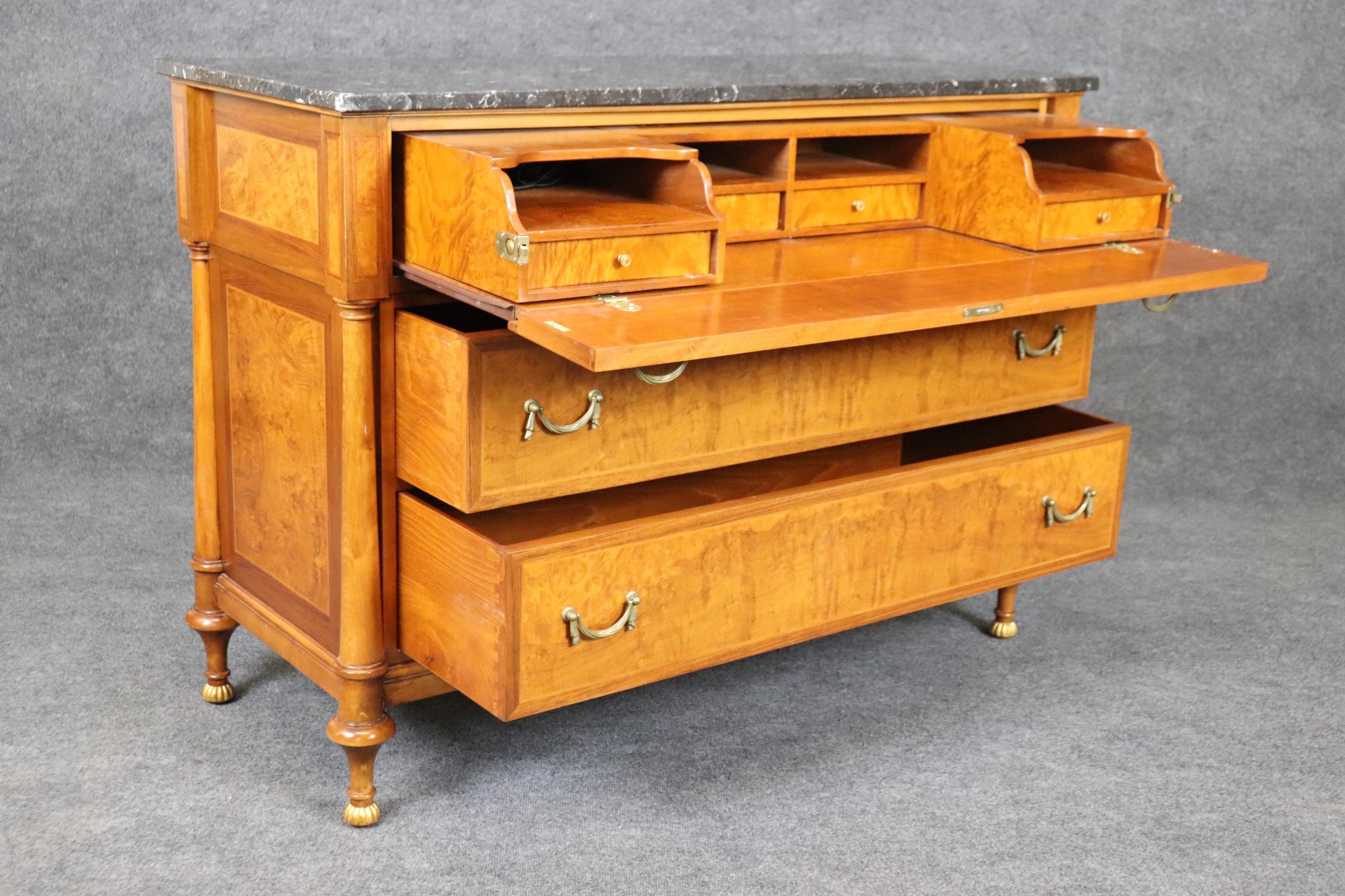 This is a gorgeous butler's commode with a dropdown desk with cubbies. The commode is made of figured cherry with beautiful brass hardware and a great marble top. Measures 53.25 wide x 38.5 tall x 22.25 deep. Dates to the 1990s era.