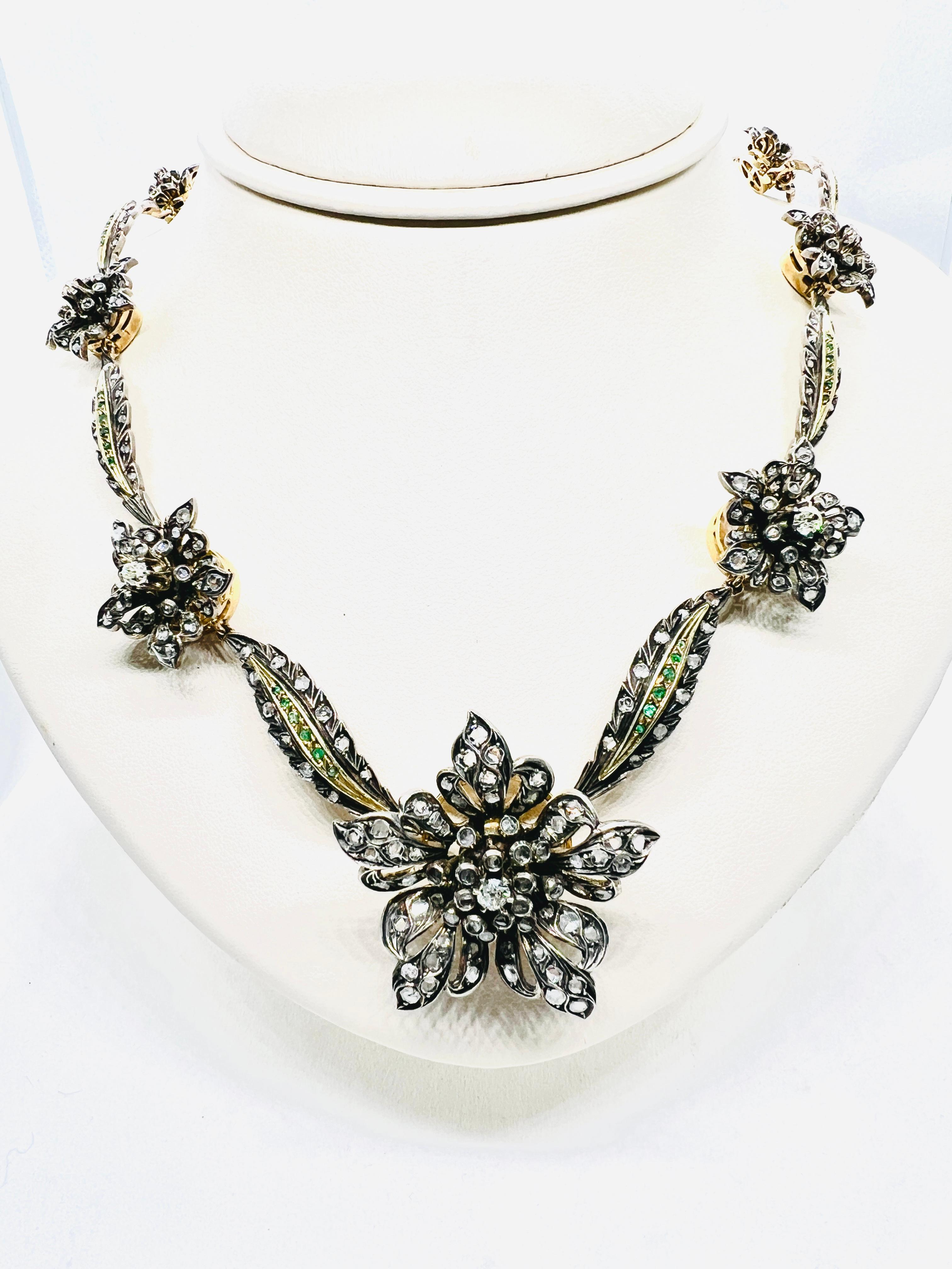 Absolutely Stunning Necklace! It is made in sterling silver and 18 Kt Yellow Gold. It features Old Mine cut and rose cut diamonds that form ten stations of flowers set 
