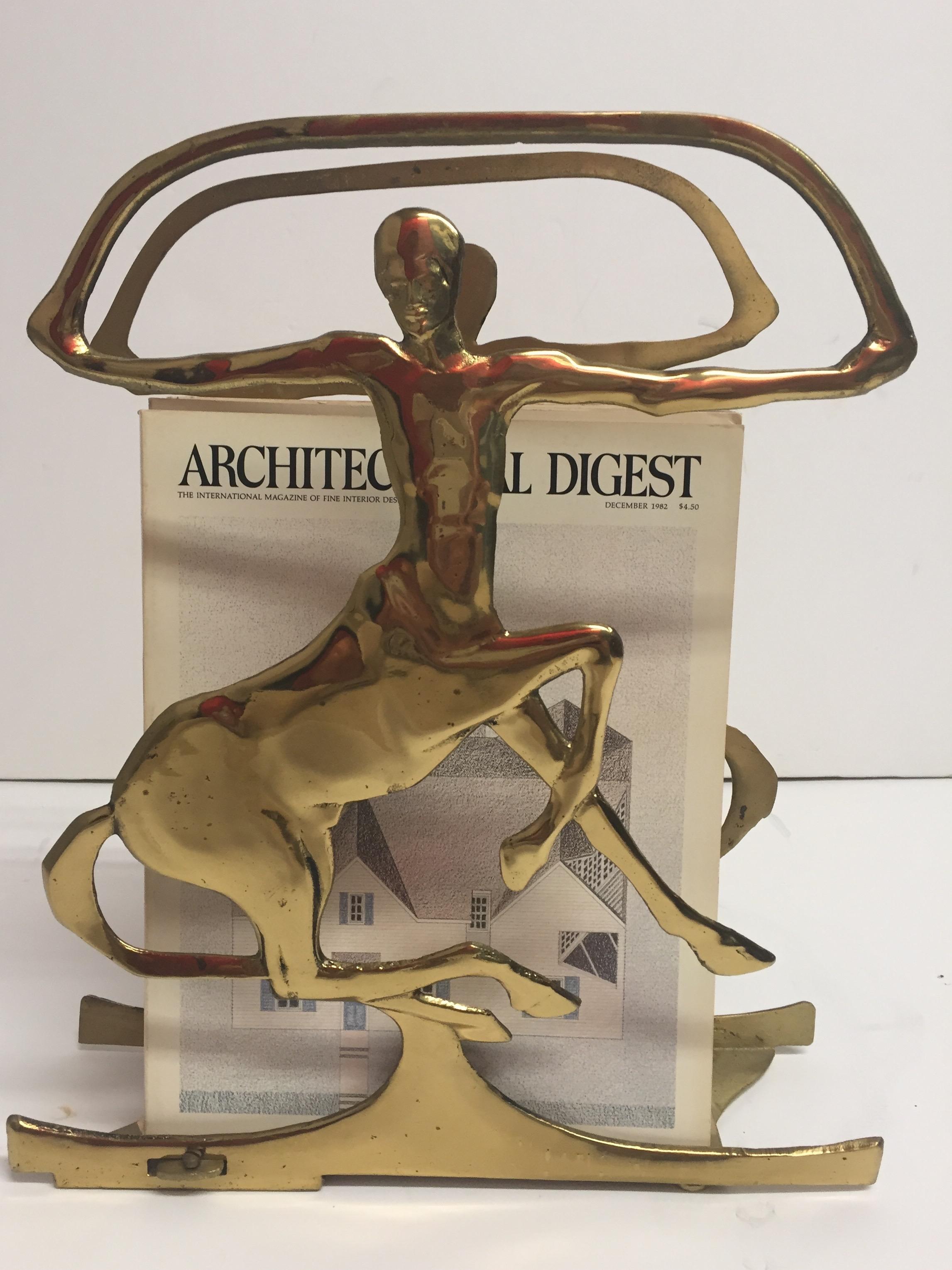 A brass sculptural magazine rack with the poetic shape of a Satyr, part man part horse.
Depth is adjustable to get smaller.