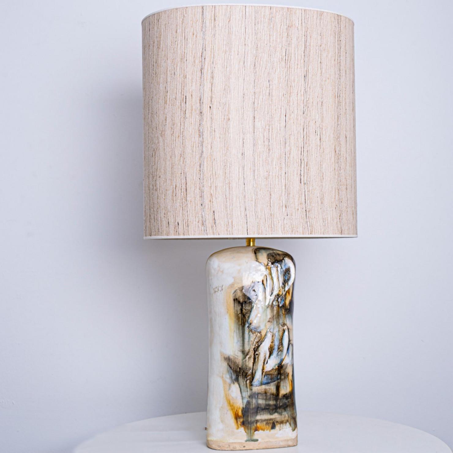 Beautiful floor table lamp by Jeppe Hagendorn, Denmark 1960s.

This stunning lamp has a ceramic base with earthy and blue tones and a beautiful glaze, making it a real eye catcher and a statement piece. The lampshade is designed by Rene Houben. This