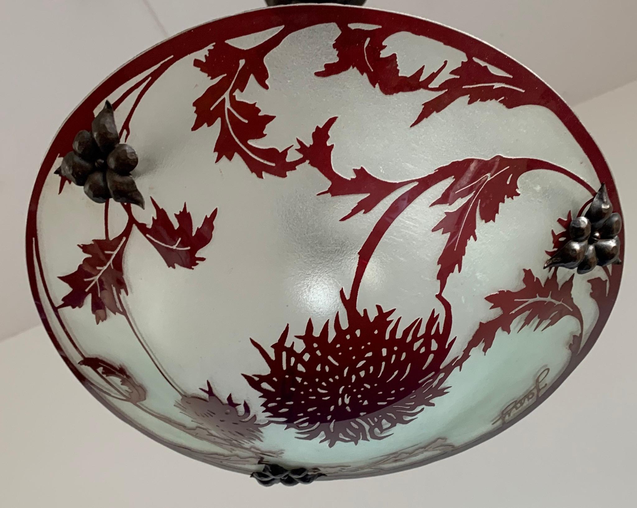 Unique and stunning work of lighting art.

If you are passionate about early 20th century decorative art then you will love this one of a kind, art glass light fixture. What you are seeing here is an extremely rare, enameled pendant, signed by