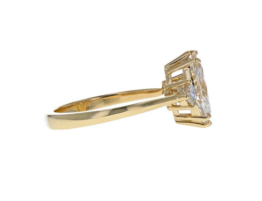 This Gorgeous Three Stone Diamond Engagement Ring with Marquise Diamond Center is flanked by two princess cut diamonds on either side. Set in yellow gold, this ring was crafted to have a raised profile to further accentuate and elevate the