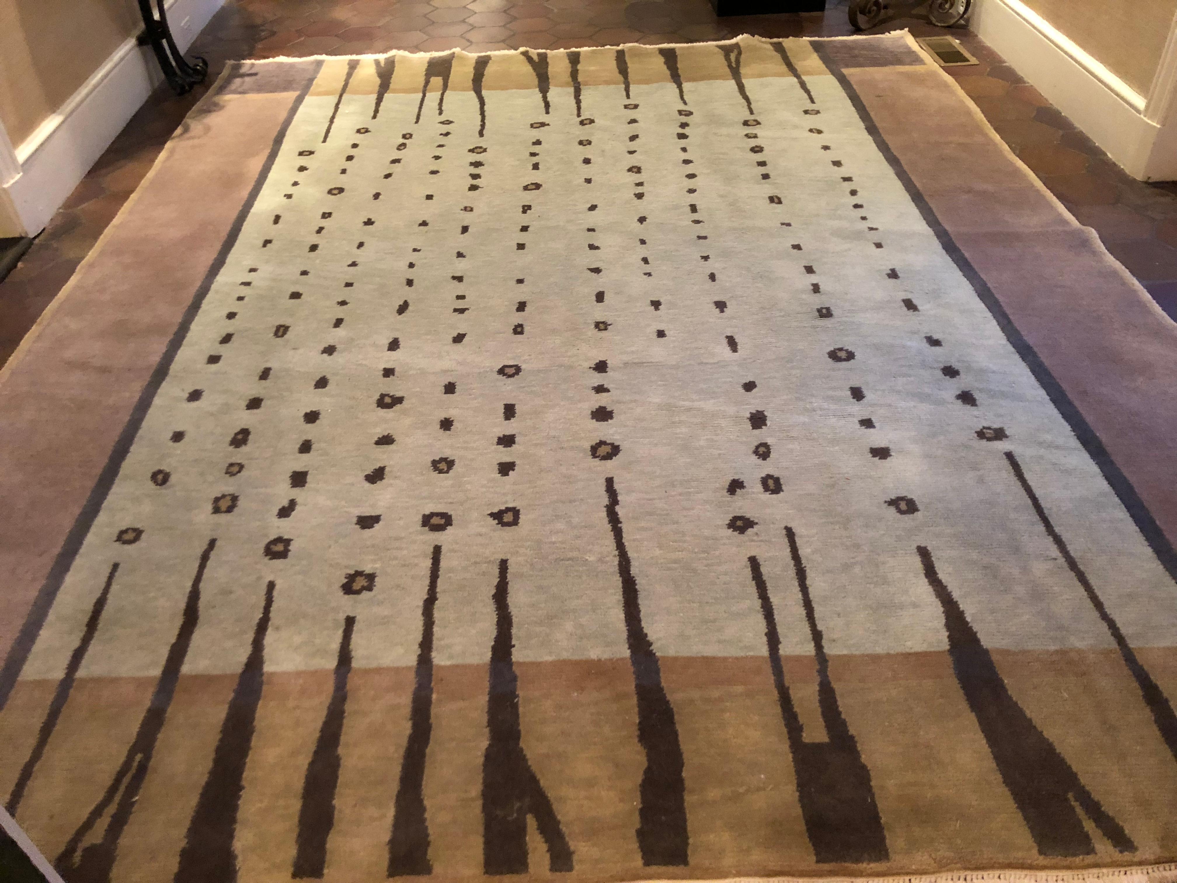 A fabulous contemporary Tibetan wool rug in muted shades of light green, brown, tan, grey and black. A unique modern design that will update any room. 100% wool; has been professionally cleaned. Measures: 8 ft 6 in wide x 10 ft 3 in long x .5 thick.