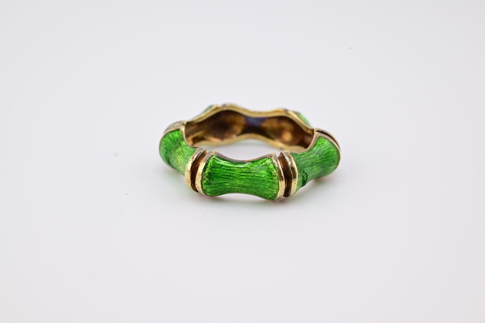 This is a striking Tiffany & Co enamel ring featuring a unique bamboo-inspired design. The ring is crafted with segments resembling bamboo stalks, finished in a vibrant green hue. Each segment is separated by gold-toned bands, adding a touch of