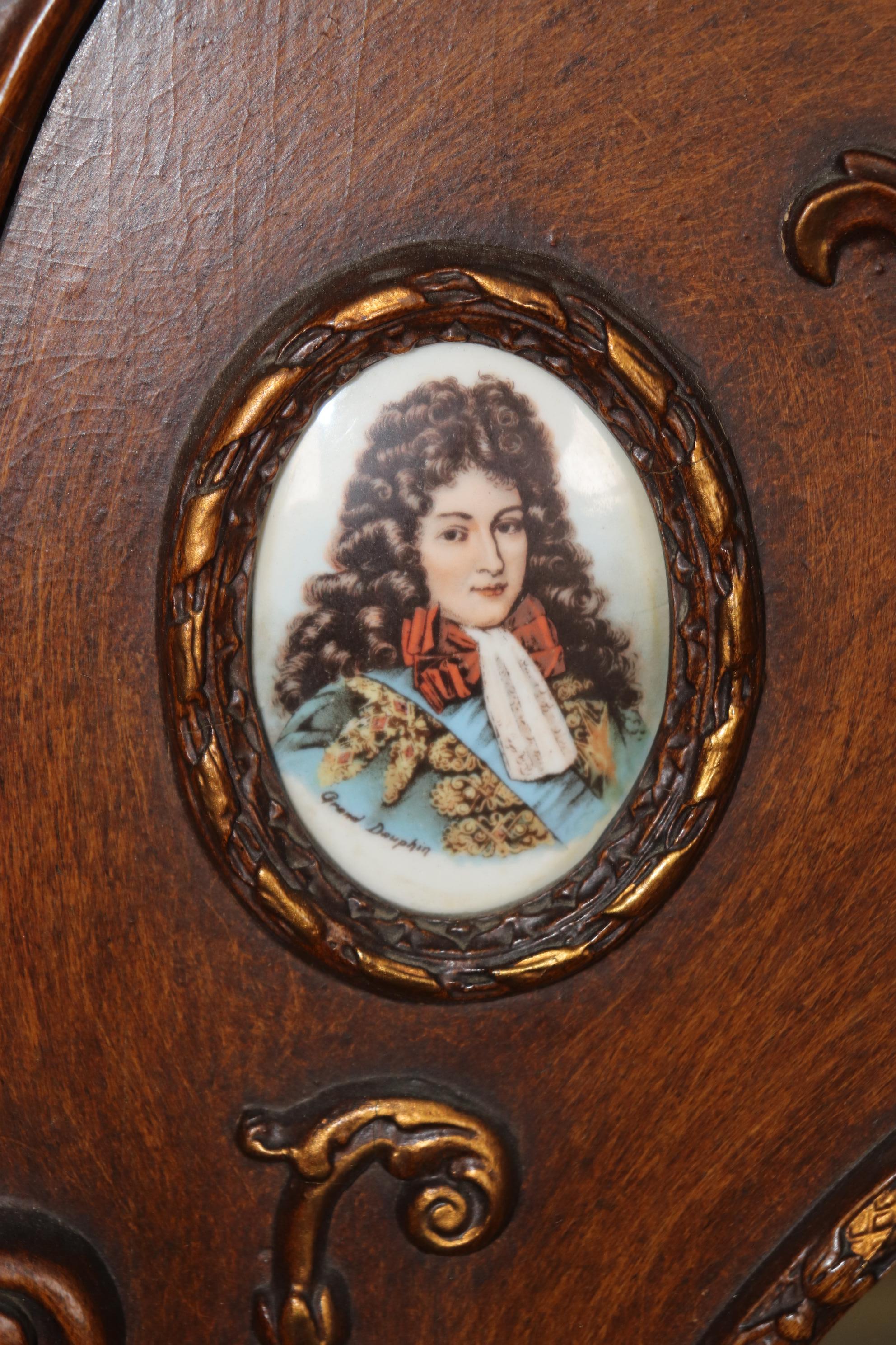 This is a very unique and gorgeous mirror possibly German with Viennese style porcelain figures encrusted in the carved walnut frame. The mirror is in good condition for its age. Measures 43.5 tall x 28 wide x 2 deep. Dates to the 1920s era. 