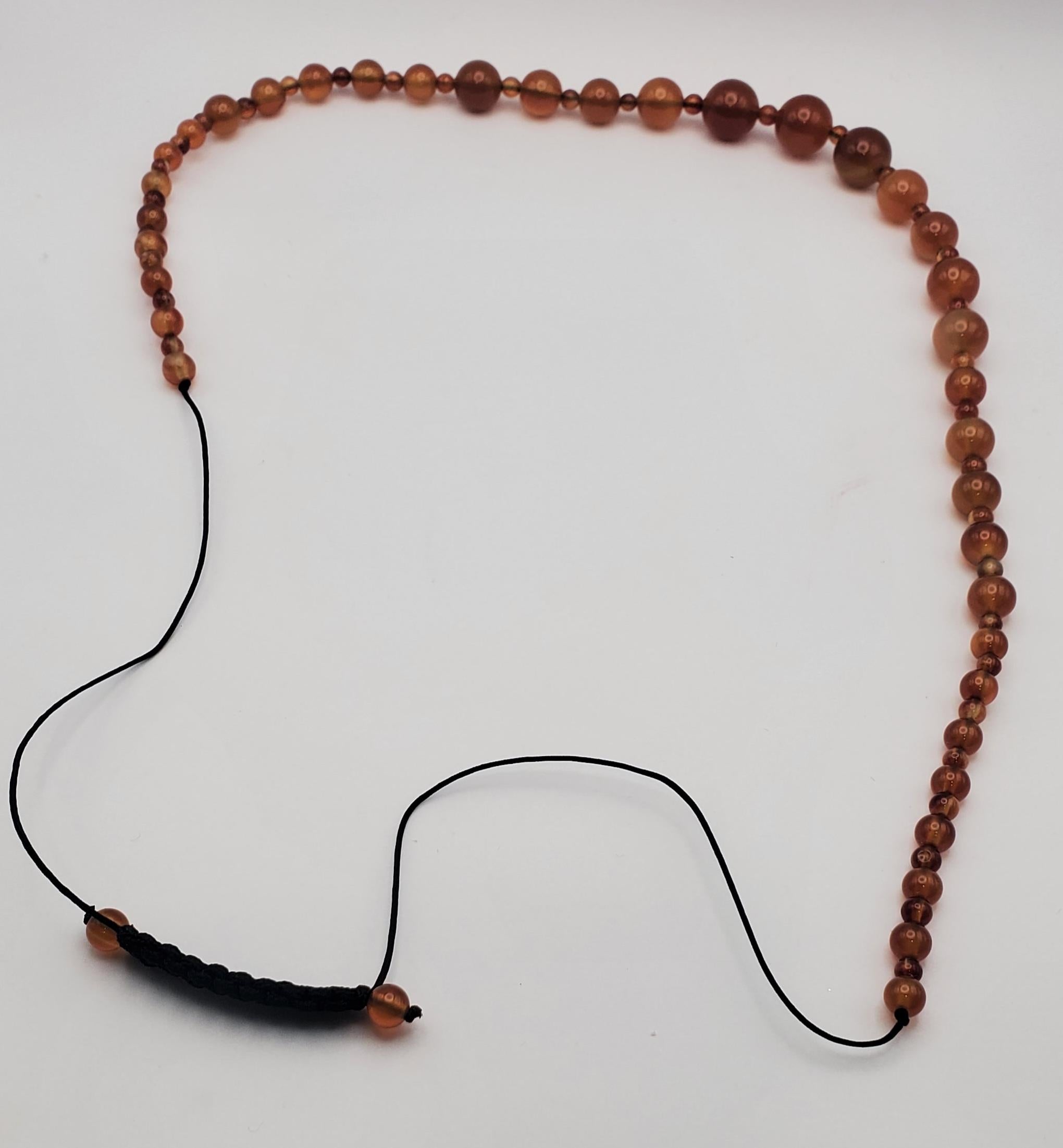 Beautiful vintage natural carnelian round bead necklace. This necklace is continuous with no clasp and finished with a sliding square knot design. This allows the necklace to be extended from 19