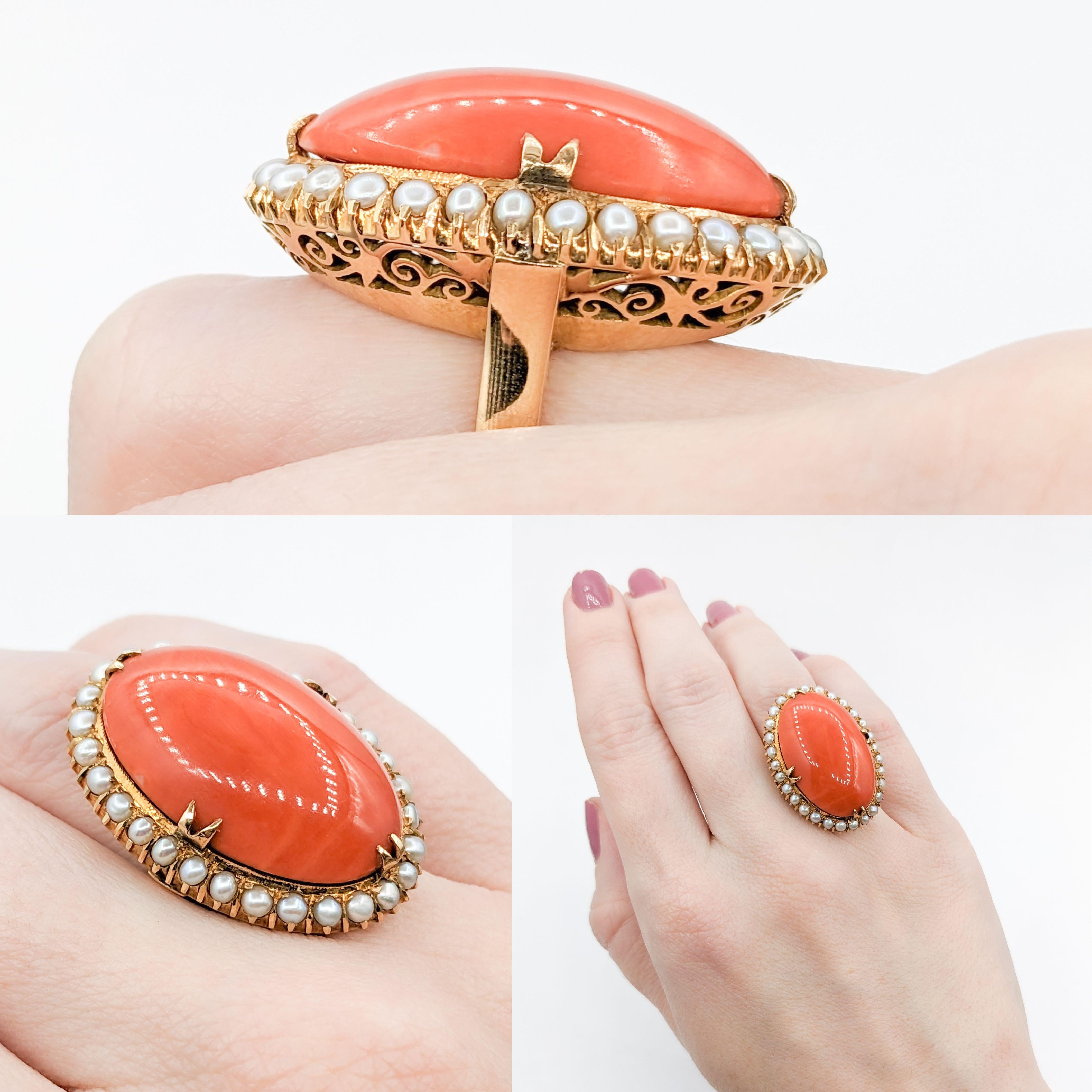 Vibrant 18k Coral & Seed Pearl Cocktail Ring

Introducing this exquisite vintage coral cocktail ring. Expertly crafted in 18k yellow gold, it prominently features a radiant 27x16mm oval Coral cabochon in a vibrant reddish-orange color. The stunning