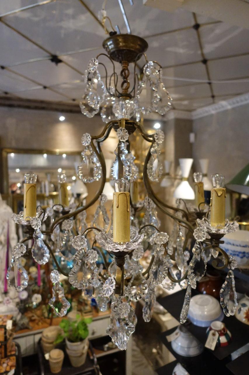 Gorgeous vintage French crystal chandelier or ceiling lamp, with a bronze curved framework. Stunningly decorated with charming clear crystals, capturing light shining from the 6 light sources. Adorned with two glass globes and a handsome central