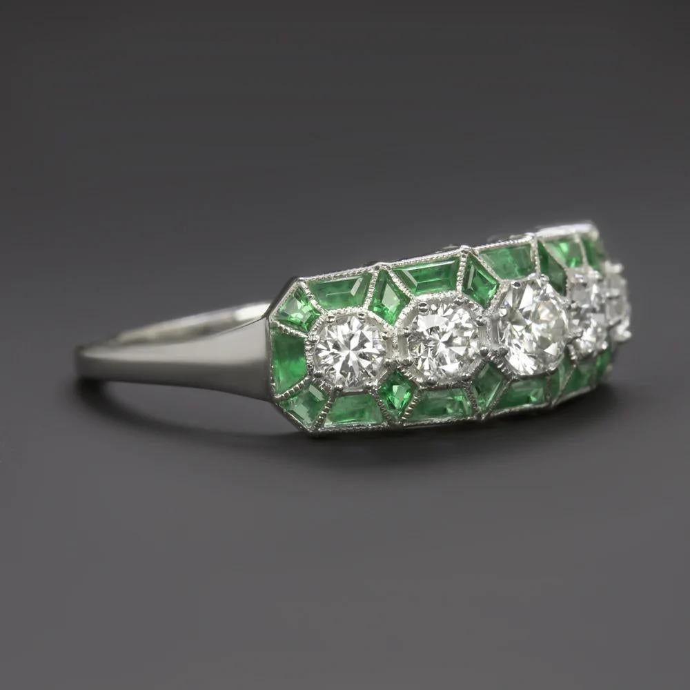 gorgeous vintage inspired diamond and emerald cocktail ring truly captures the iconically stylish aesthetic of the Art Deco era! The chic geometric design features a 0.60ct row of vibrant diamonds surrounded by spring green calibre cut emeralds. The
