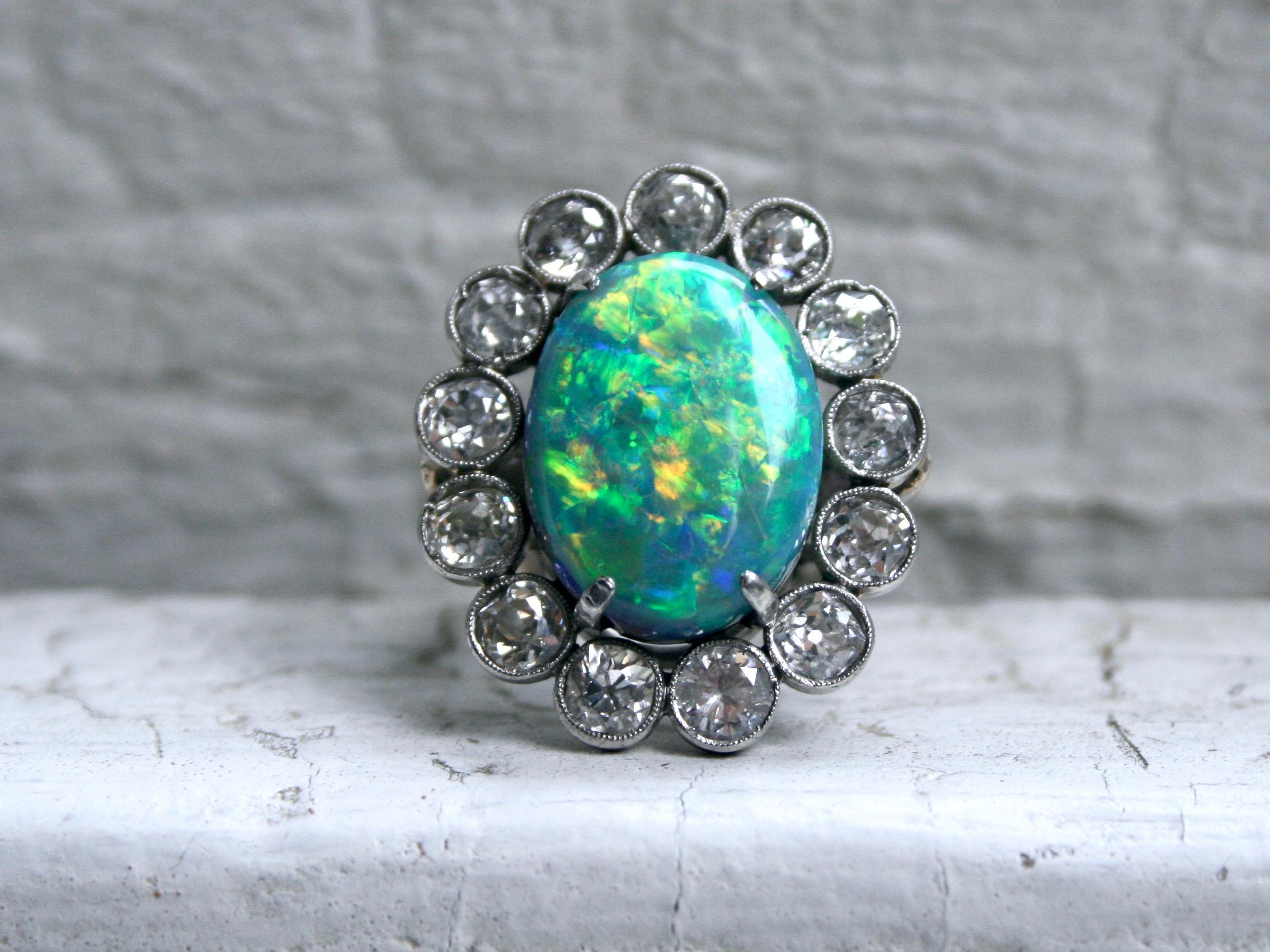 This Gorgeous Vintage Opal and Diamond Halo Ring certainly has caught my attention! Cause it is AMAZING! Crafted in beautiful Platinum, the design features a wonderful Halo of Diamonds around a trull Stunning Opal center! In the center, the ring