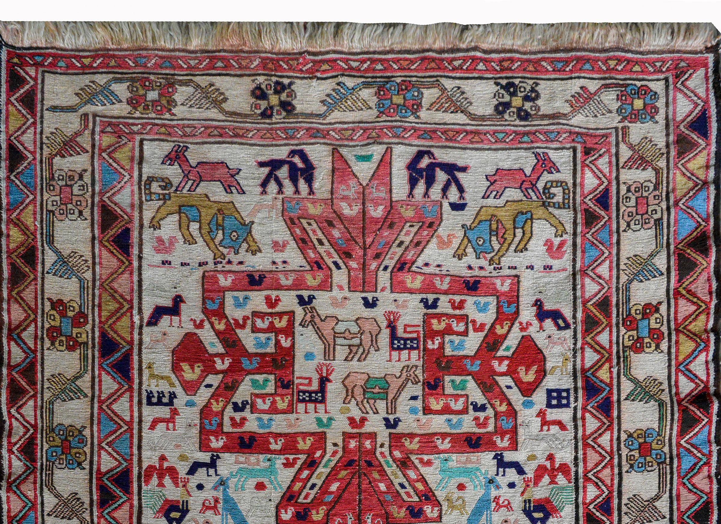 A gorgeous vintage Persian Soumak rug with mural animals including chickens, camels, lions, goats, and tigers, all woven in red, indigo, pink, green, and gold against a white background, and surrounded by wide geometric pattered borders flanking a