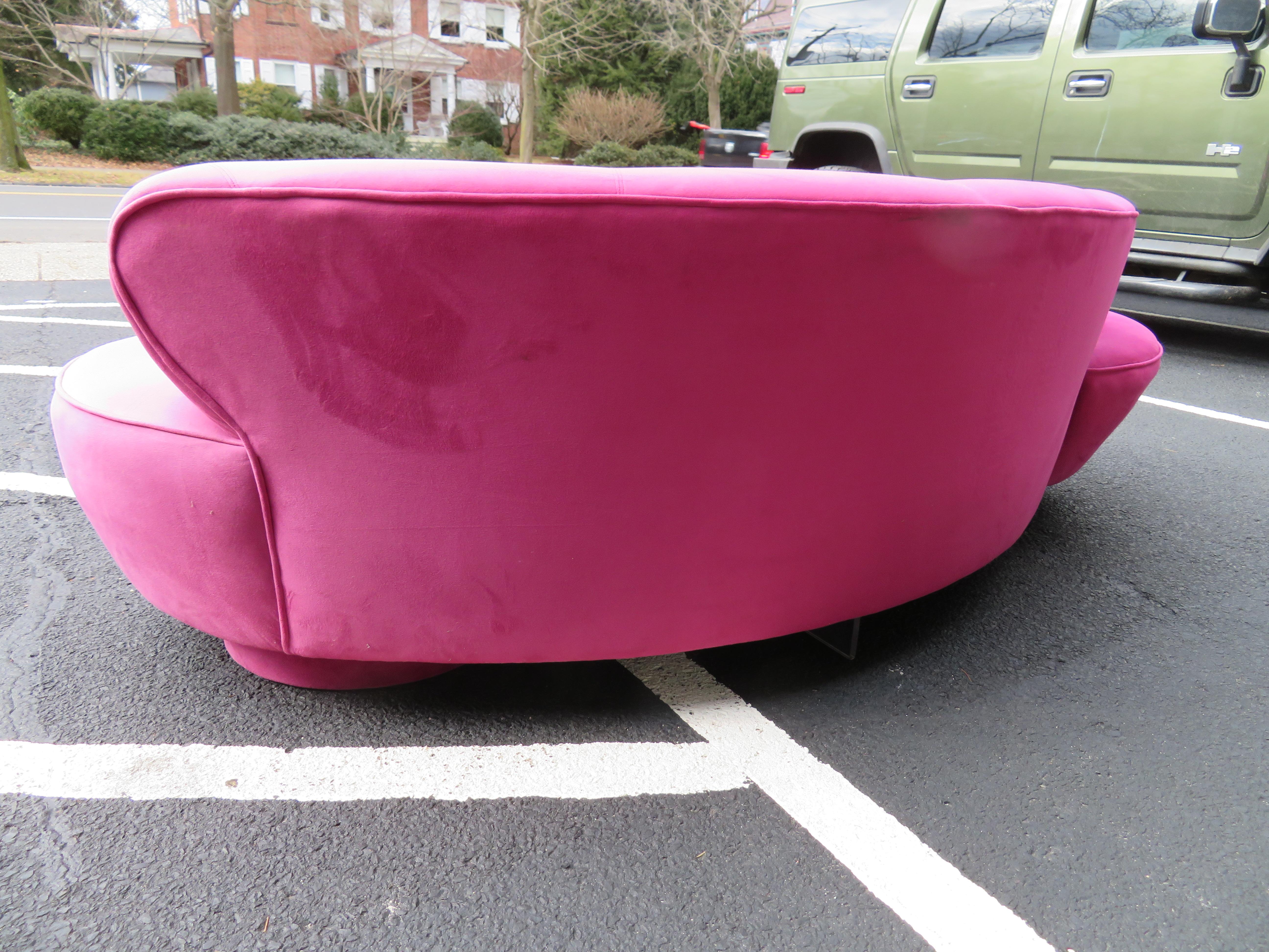 Stunning hot pink ultra-suede serpentine cloud sofa designed by Vladimir Kagan and manufactured by Directional. Inc. The original fabric does show some wear, reupholstery is recommended.