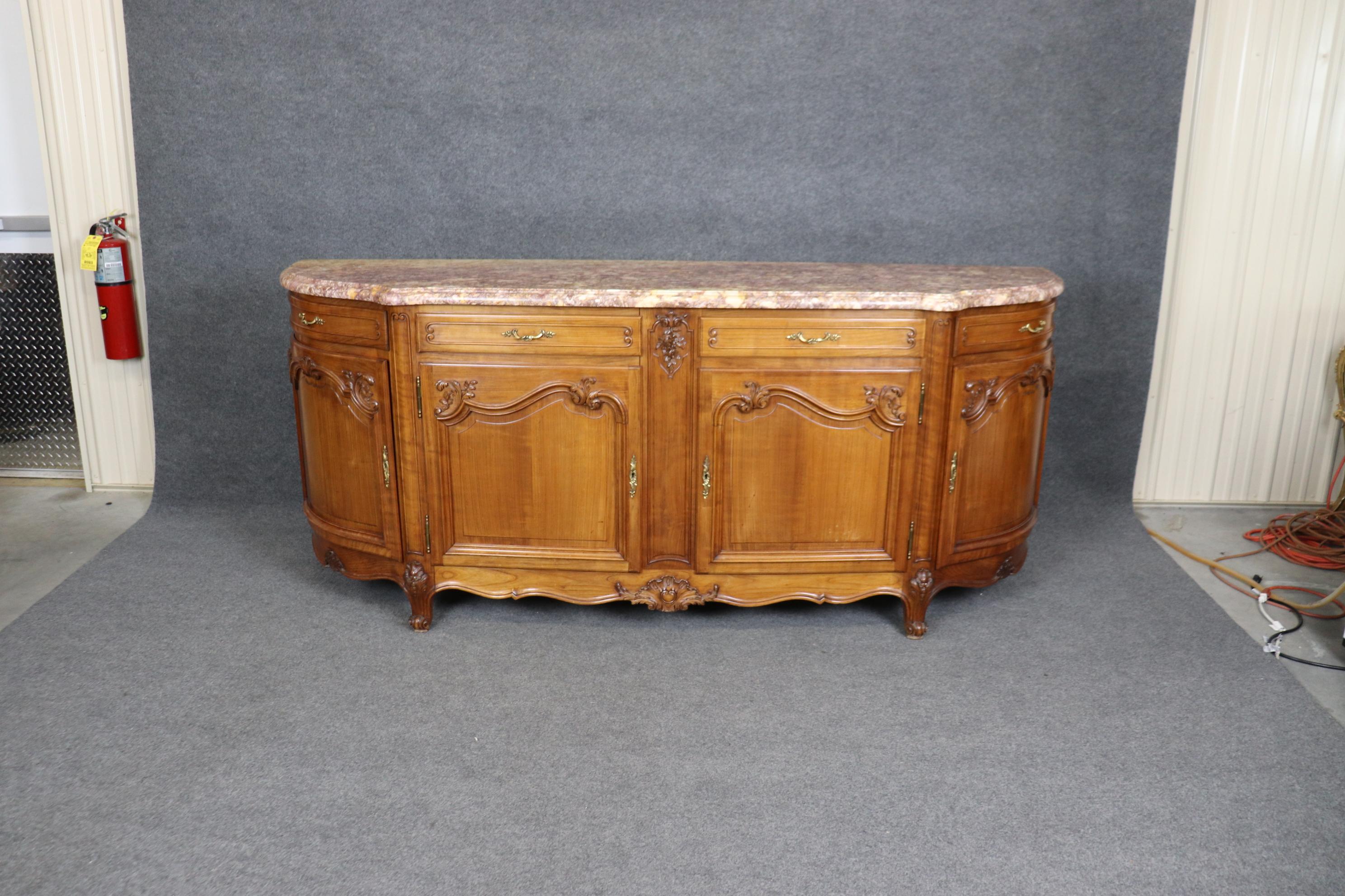 This is a truly grand and extremely beautiful French buffet or sideboard with a fantastic marble top with purple and yellow colors that resemble a watercolor painting. The sideboard is in good condition and has no major issue or defects worthy of