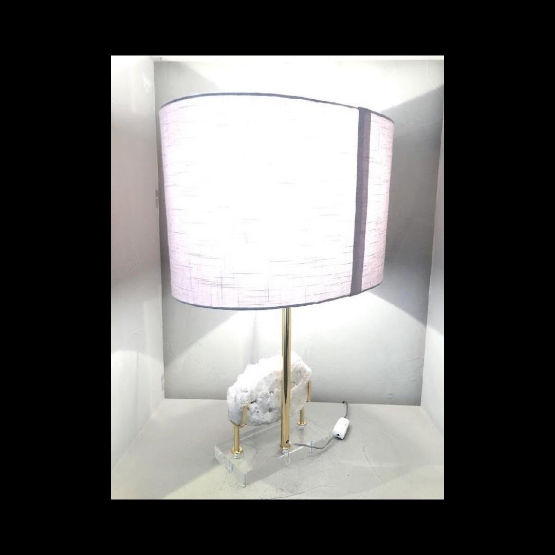Unique table lamp created with selected rock crystal druse. The elegant base is in rectangular acrylic, polished and varnished lace holder. 

The process of creation goes through several craftsmen before reaching the final stage, and each