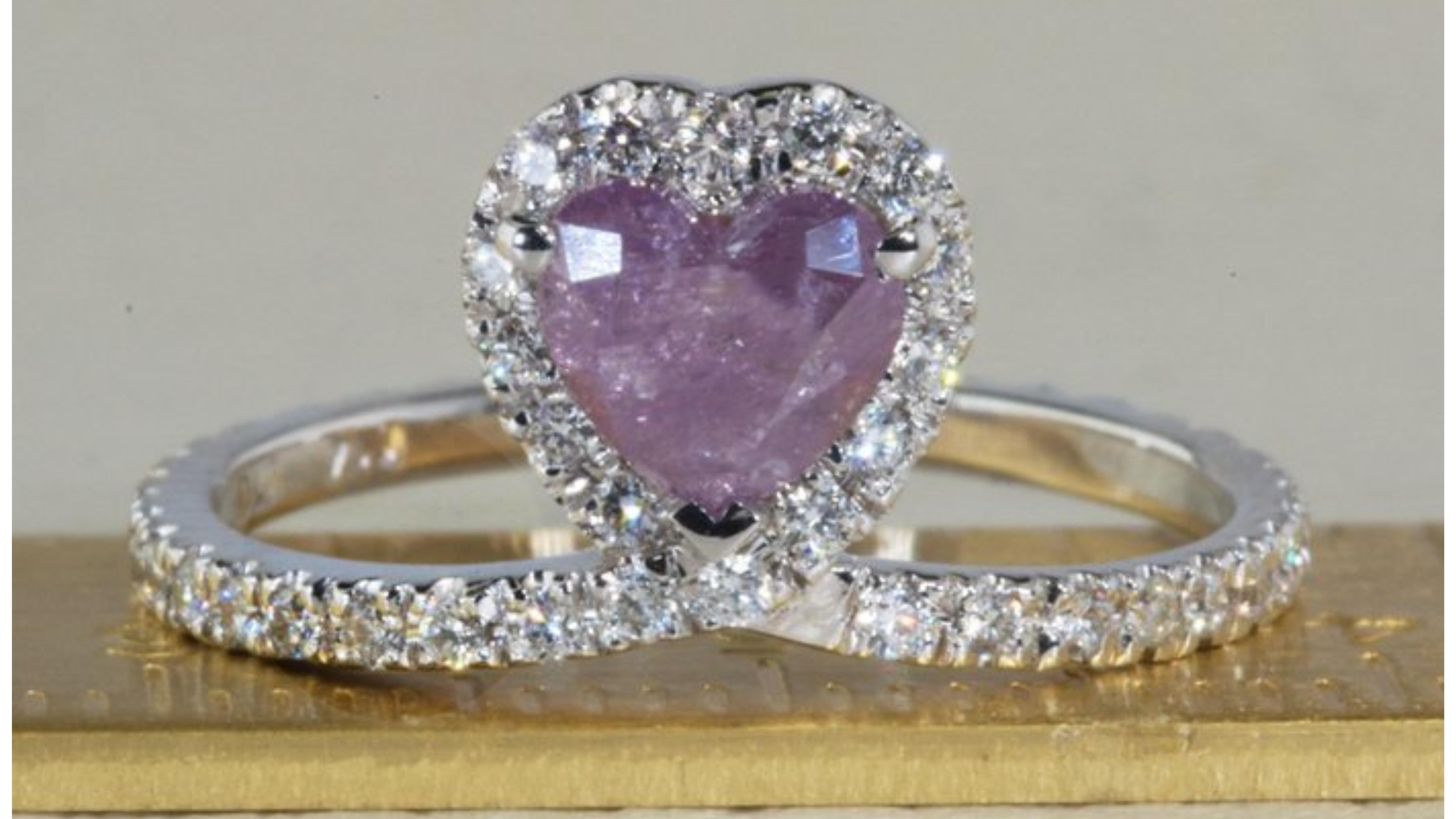 Very Rare purple heart diamond mounted in a white gold 18k Ring with ideal round brilliant diamonds around the purple heart in a total weight of 1.06 carat

Product Details: 

Metal: 18k White Gold

Main stone: 1 Pc Heart Diamond
Colour: