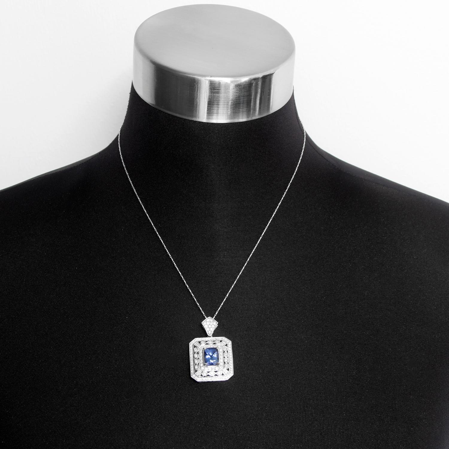Gorgeous White Gold Diamond and Tanzanite Pendant Necklace - This gorgeous necklace is 18 inches long and has approx 5.30 total carat weight. The pendant is 1.5 inches by 1 inch and has a blue tanzanite measuring 10x8.34x6.4mm that is surrounded by