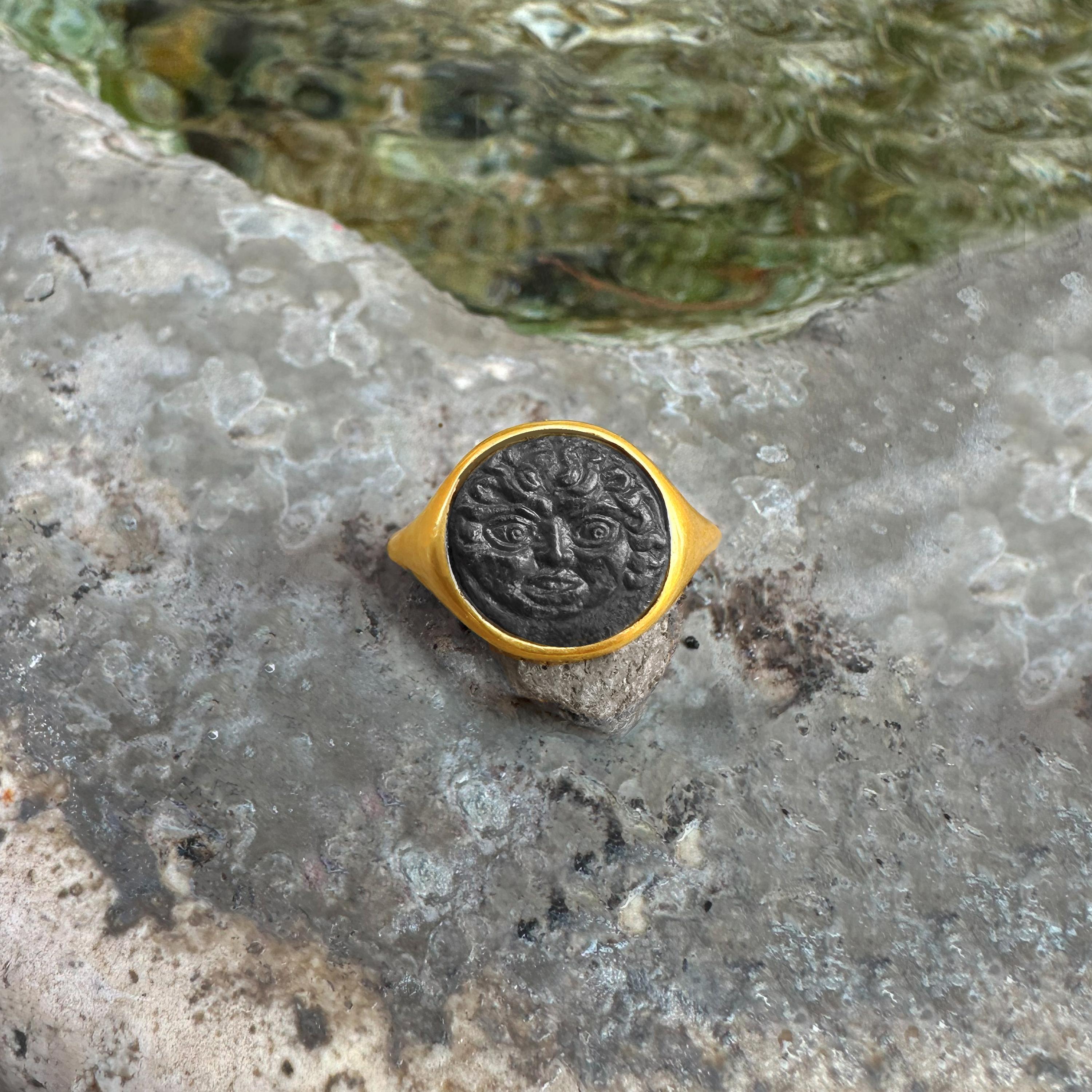 Questo squisito anello in oro 18 kt presenta un'autentica moneta greca in bronzo risalente al 420-405 a.C., ornata da un'impressionante raffigurazione della Gorgone, una figura mitica ricca di tradizione antica.

Le Gorgoni, composte da tre sorelle