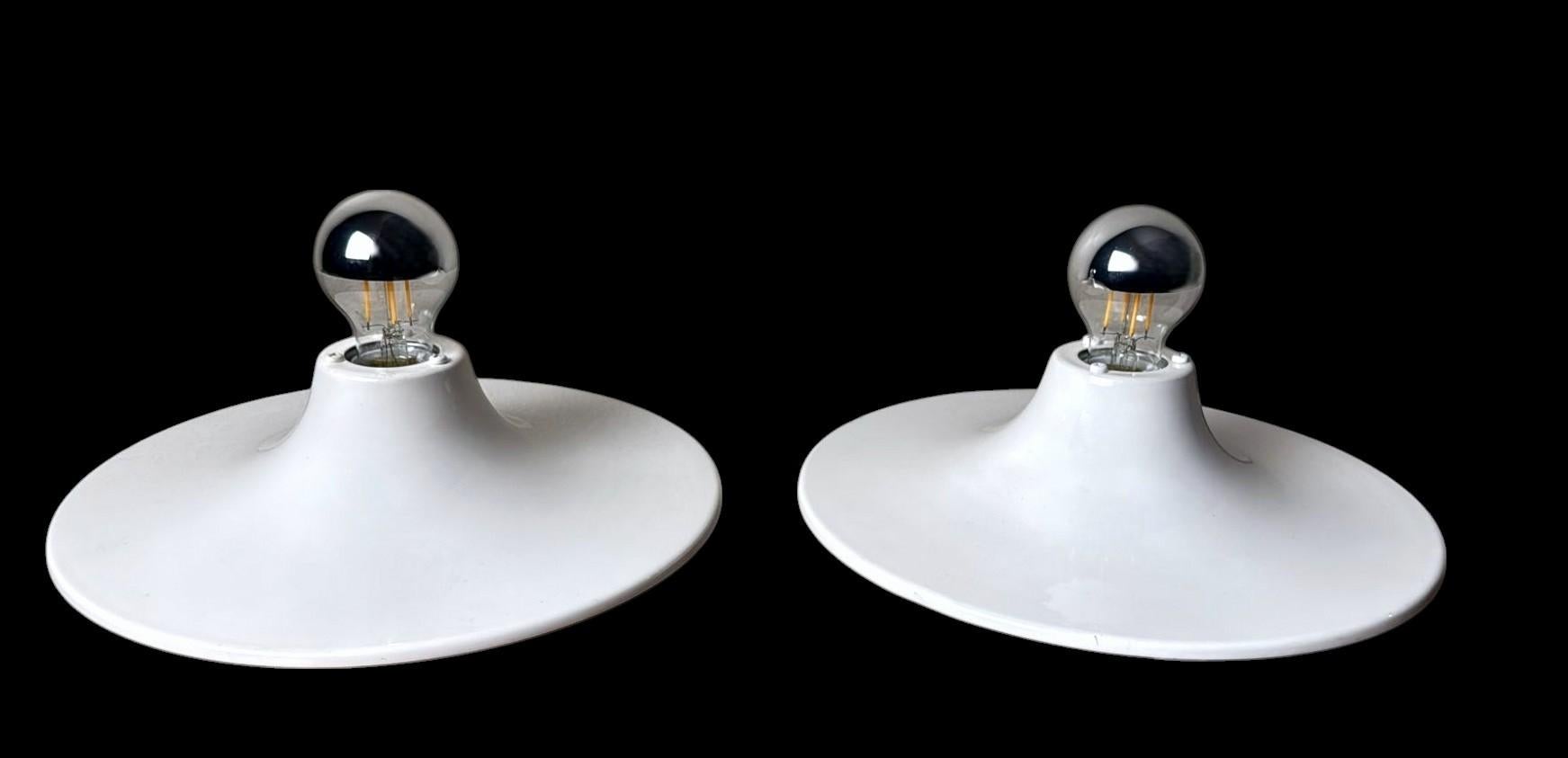 We kindly invite you to read the full description below. We always strive to provide accurate technical and historical information to ensure the authenticity and value of our items.
An elegant and iconic pair of Italian wall or ceiling lamps,