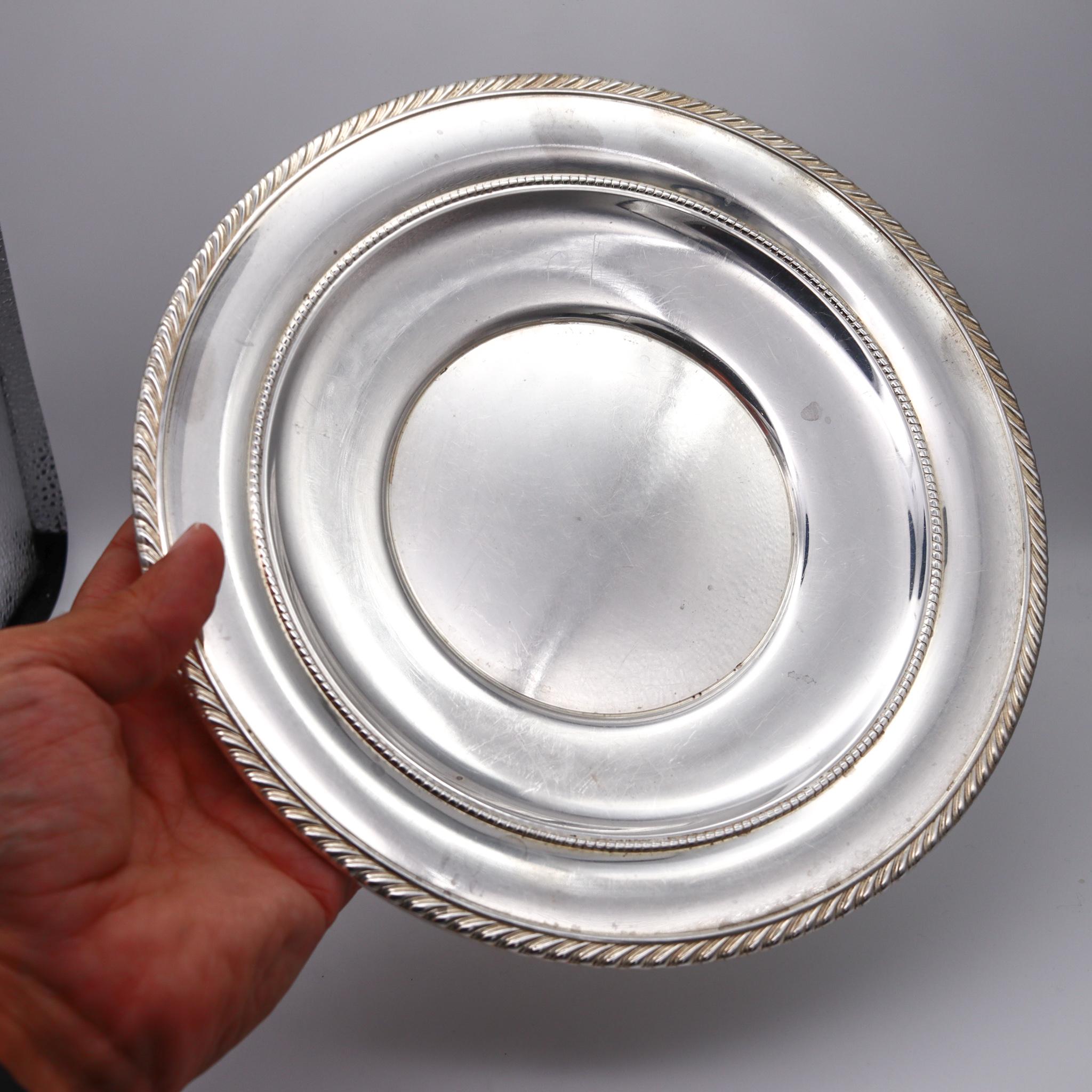 Classic round tray designed by Gorham.

Beautiful vintage American piece from Gorham Company. A large Gadroon model round tray crafted in solid .925/.999 sterling silver, back in the 1960. Designed to be used for sandwiches with a round shaped