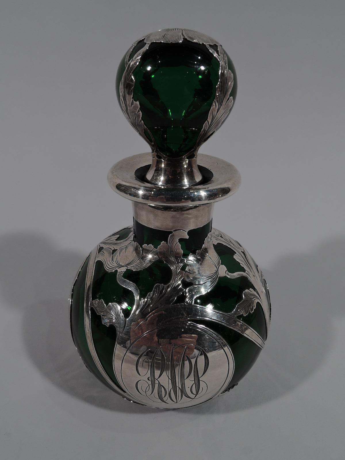 Turn-of-the-century Art Nouveau Classical glass perfume with engraved silver overlay. Globular bottle with short neck and everted rim. Ball stopper. Overlay rinceaux pattern with leafing and flowering scrolls. Round cartouche engraved with