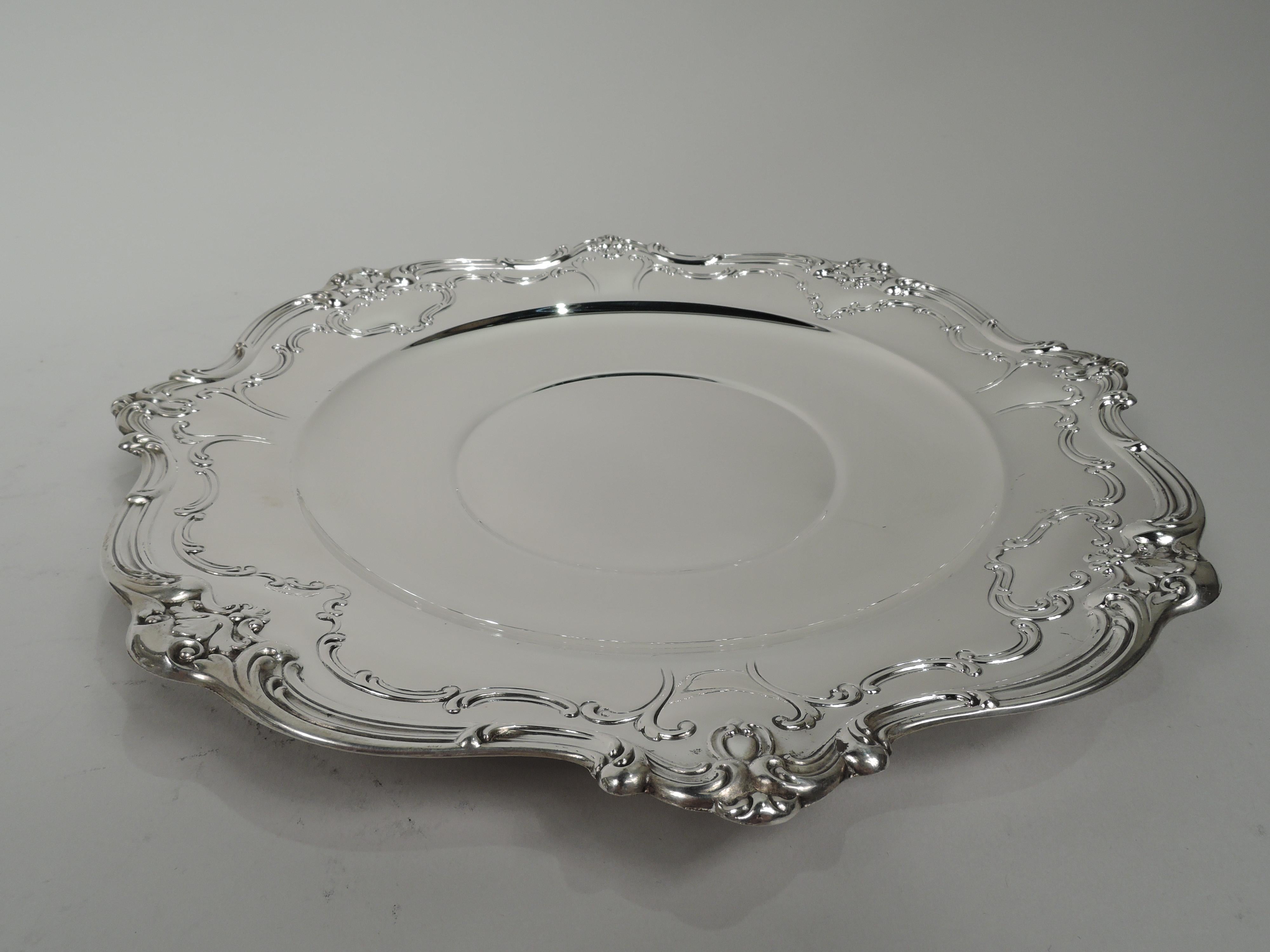 Chantilly-Duchess sterling silver cake plate. Made by Gorham in Providence in 1951. Round well, curved shoulder, and chased scrolled rim interspersed with leaves. A nice piece in the perennially popular late Victorian pattern. Fully marked including