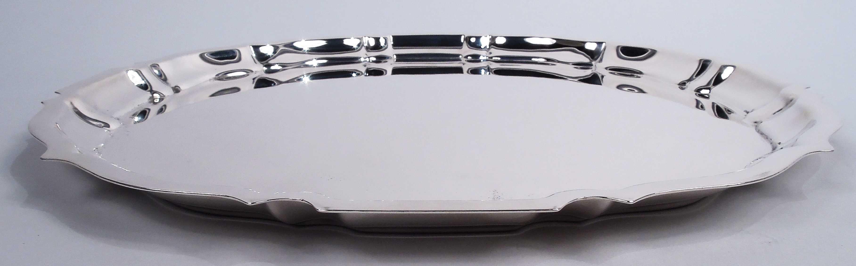 Chippendale sterling silver tray. Made by Gorham in Providence in 1943. Round with flat ogee piecrust rim. Traditional with nice heft. Fully marked including maker’s stamp, date code, pattern name, and no. 42612. Weight: 25.4 troy ounces. 