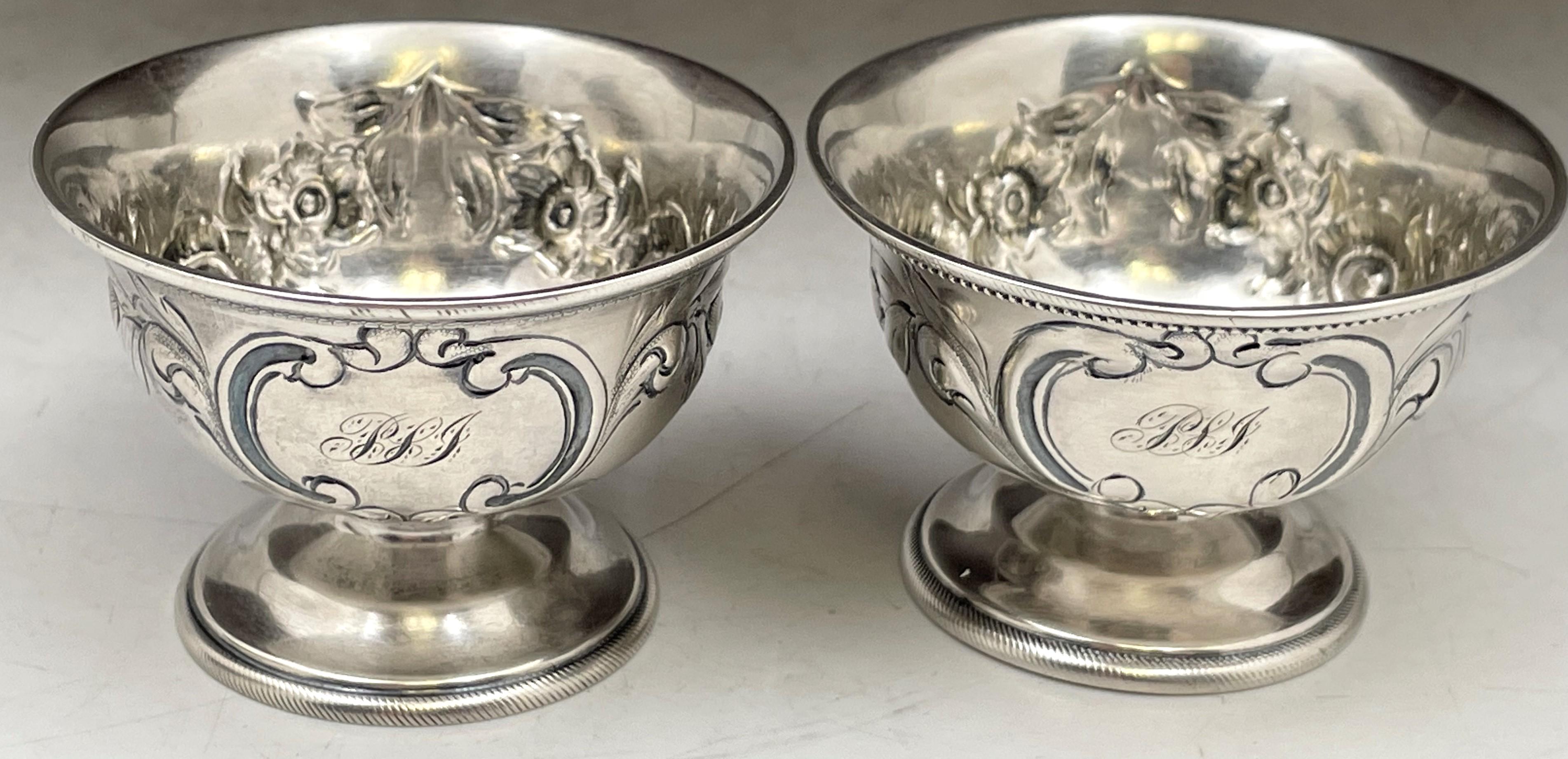 Pair of Gorham, coin silver open salt cellars, made circa 1855 to 1860, beautifully adorned with floral and cartouche motifs. They measure 2 1/2'' in diameter by 1 2/3'' in height, and bear hallmarks and a monogram as shown. 

During the heyday of