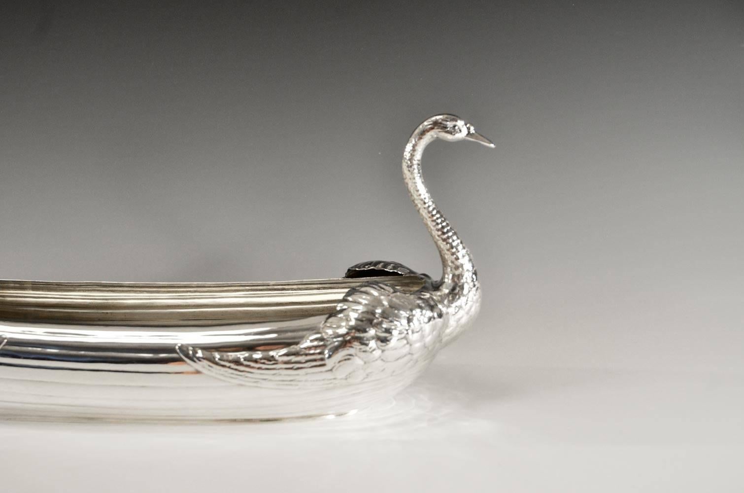 Signed with the Gorham and Durgin mark, this rare sterling silver centerpiece features a double swan boat design. Reminiscent of the Boston commons boats, the double swans decorate either end with elegant sweeping necks and the open body allows for