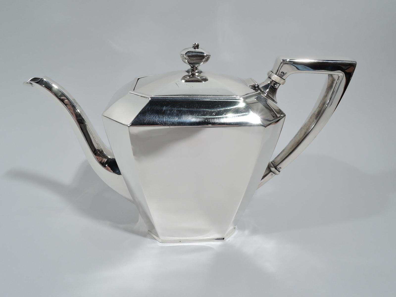 Fairfax sterling silver coffee and tea set. Made by Gorham and Durgin (part of Gorham) in Providence, ca 1940. This set comprises 5 pieces: Coffeepot, teapot, creamer, sugar, and waste bowl.

Each: Straight and tapering body with chamfered