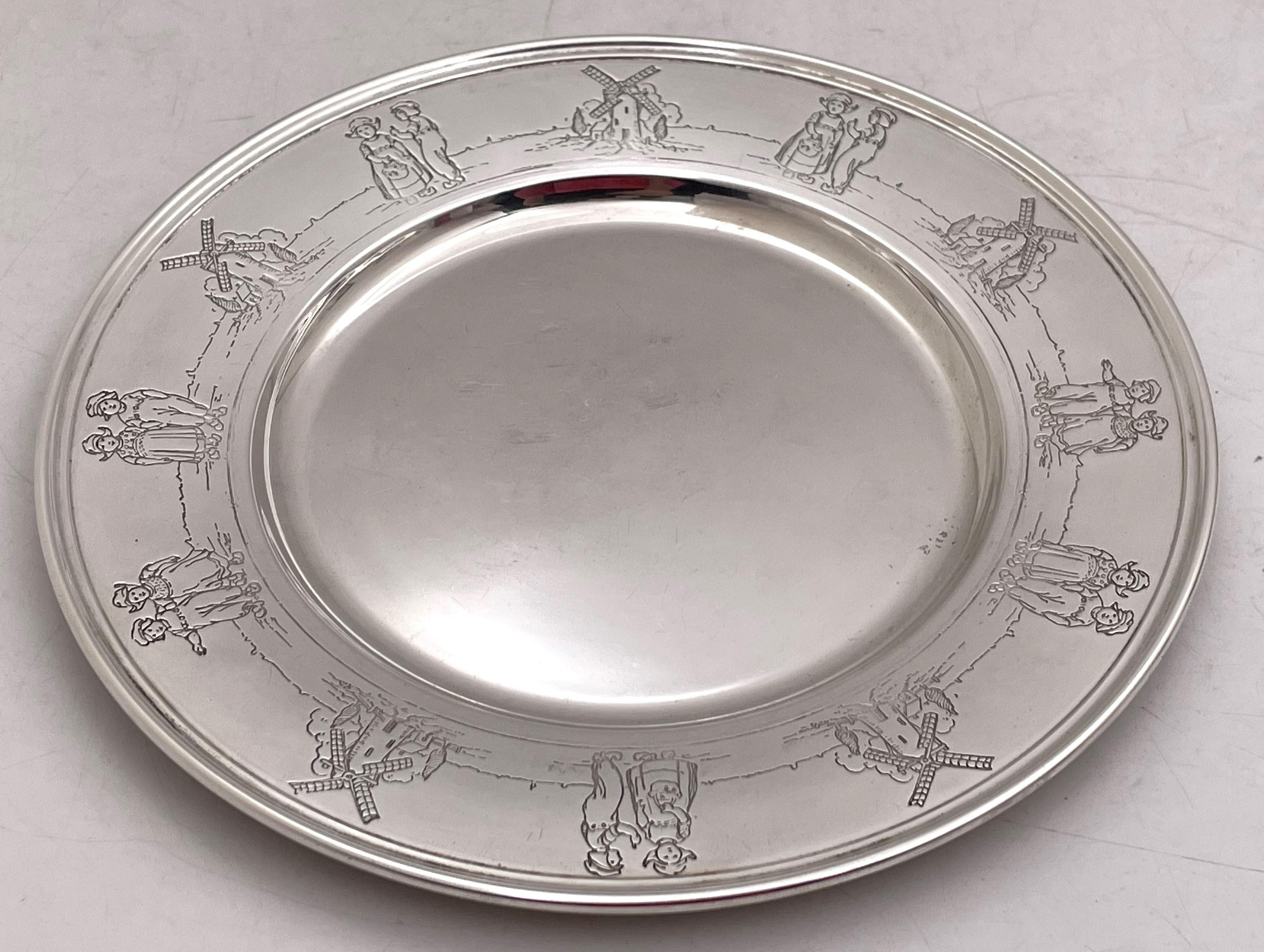Gorham sterling silver child bowl (gilt inside) and underplate from 1927, beautifully adorned with children pursuing outdoor activities. The bowl measures 4 1/4'' in diameter by 1 7/8'' in height while the underplate measures 6 1/3'' in diameter.