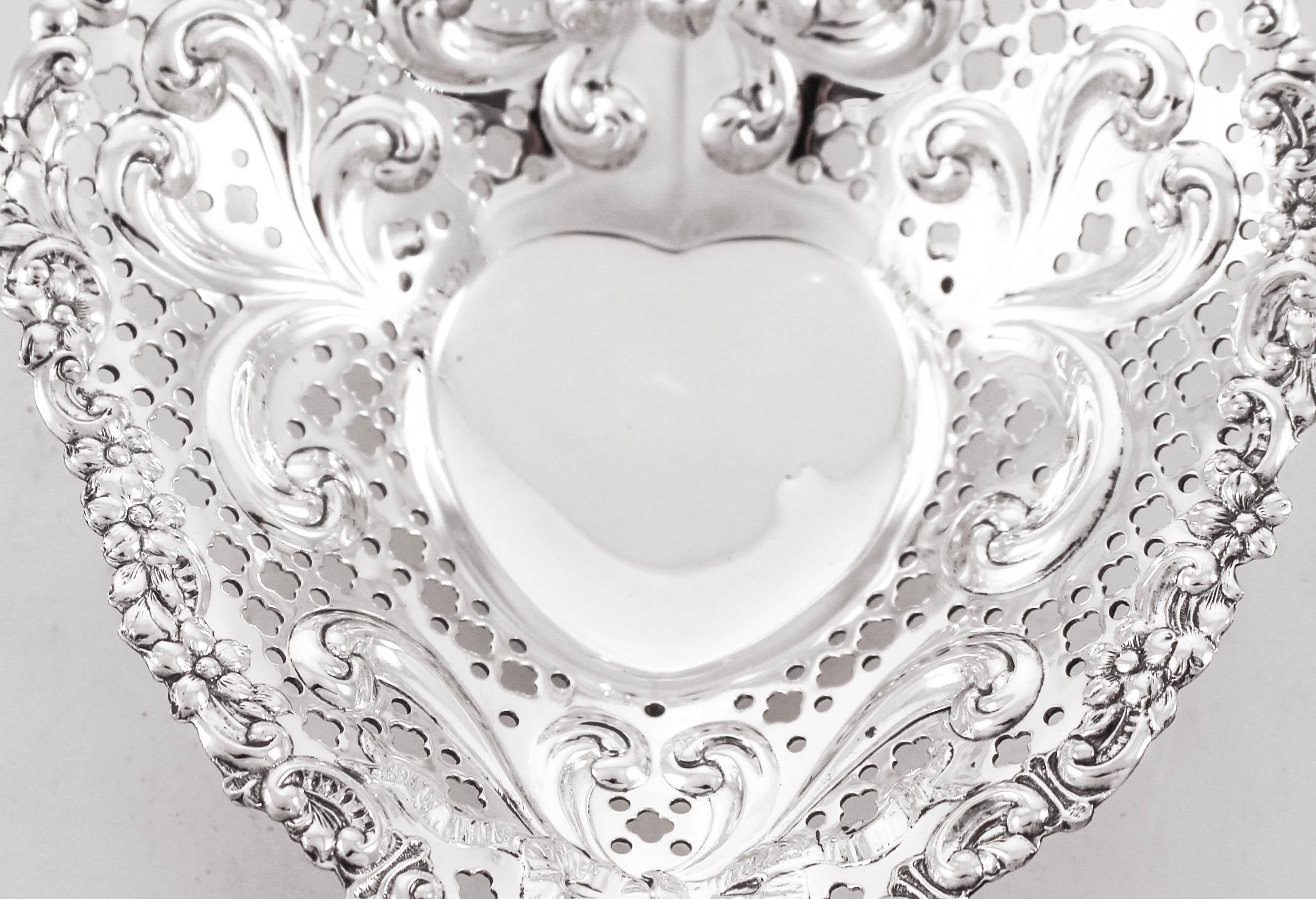 Proudly offering a sterling silver heart-shaped candy dish. It is reticulated and has a rich design going around the edge. It stands on three balls, lifting it off the surface. It’s always a perfect time to tell someone you love them!