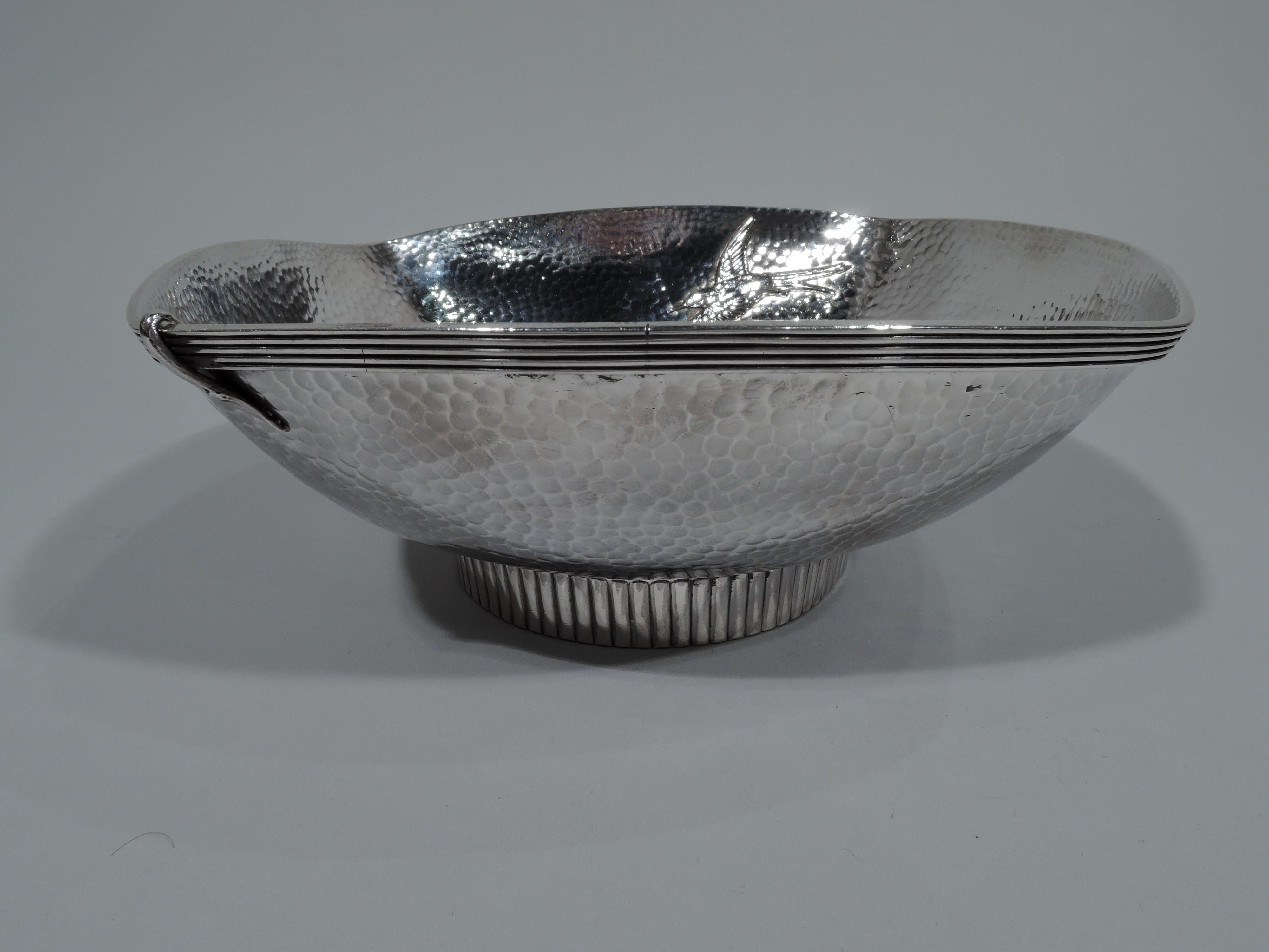 Japonesque sterling silver bowl. Made by Gorham in Providence in 1879. Four curved sides and short round ribbed foot. A pair of humming birds with flapping wings go beak-to-beak perched on a leafy branch. A third flies solo. Hand-hammered honeycomb
